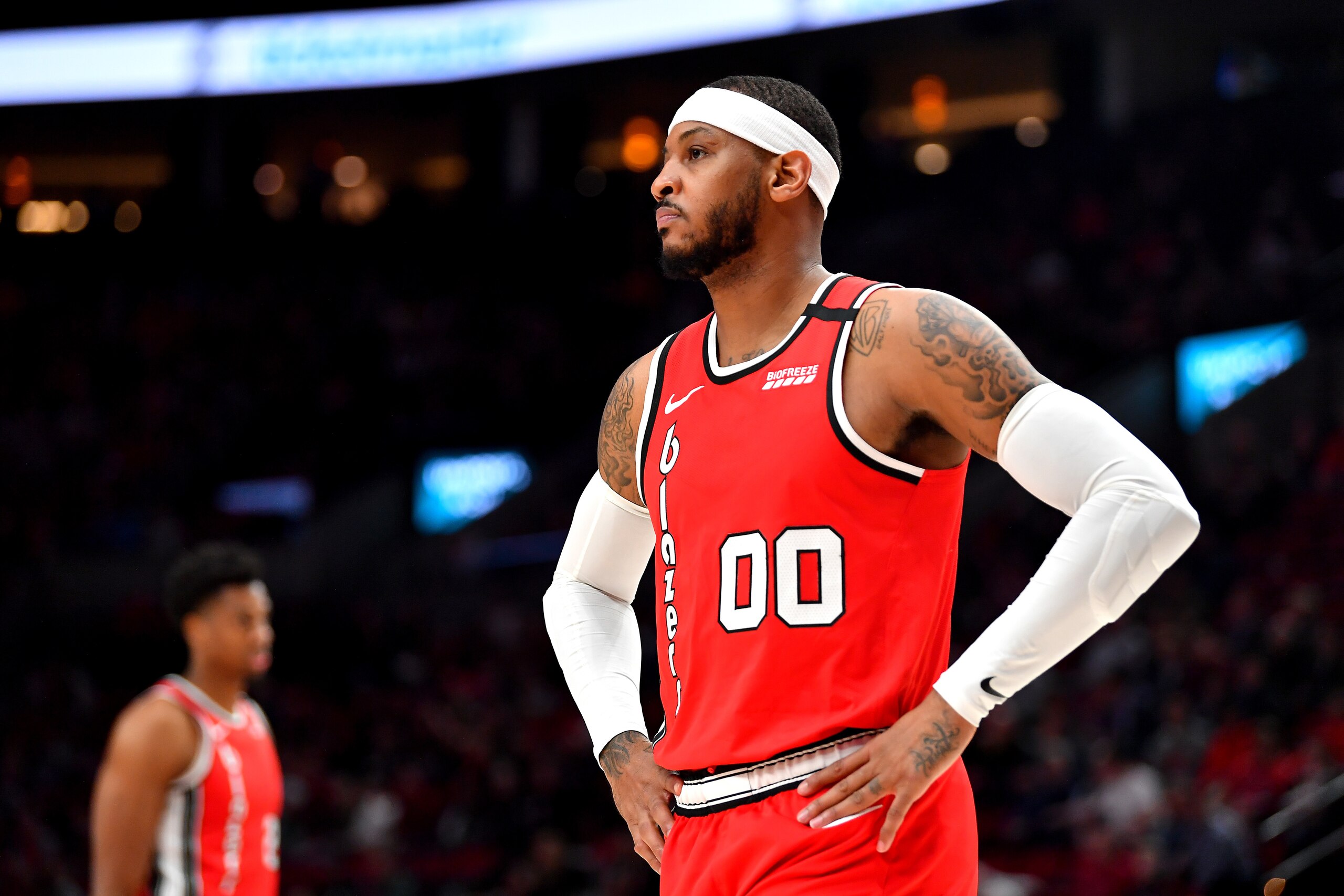 PORTLAND, OREGON - MARCH 10: Carmelo Anthony #00 of the Portland Trail Blazers (R) and Hassan Whiteside #21 look on during the second half of the game against the Phoenix Suns at the Moda Center on March 10, 2020 in Portland, Oregon. The Portland Trail Bl PORTLAND, OREGON - MARCH 10: Carmelo Anthony #00 of the Portland Trail Blazers (R) and Hassan Whiteside #21 look on during the second half of the game against the Phoenix Suns at the Moda Center on March 10, 2020 in Portland, Oregon. The Portland Trail Bl