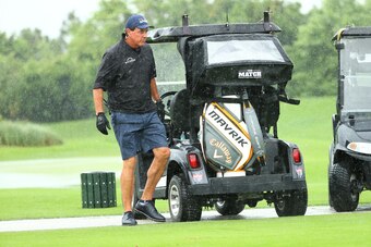 HOBE SOUND, FLORIDA - MAY 24: Phil Mickelson walks next to his cart on the range in the rain during The Match: Champions For Charity at Medalist Golf Club on May 24, 2020 in Hobe Sound, Florida. (Photo by Mike Ehrmann/Getty Images for The Match)