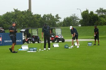 HOBE SOUND, FLORIDA - MAY 24: Tiger Woods. former NFL player Peyton Manning, NFL player Tom Brady of the Tampa Bay Buccaneers and Phil Mickelson warm up on the range prior to The Match: Champions For Charity at Medalist Golf Club on May 24, 2020 in Hobe S