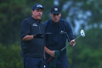 HOBE SOUND, FLORIDA - MAY 24:  Phil Mickelson reads a putt for NFL player Tom Brady of the Tampa Bay Buccaneers on the 17th green during The Match: Champions For Charity at Medalist Golf Club on May 24, 2020 in Hobe Sound, Florida. (Photo by Mike Ehrmann/
