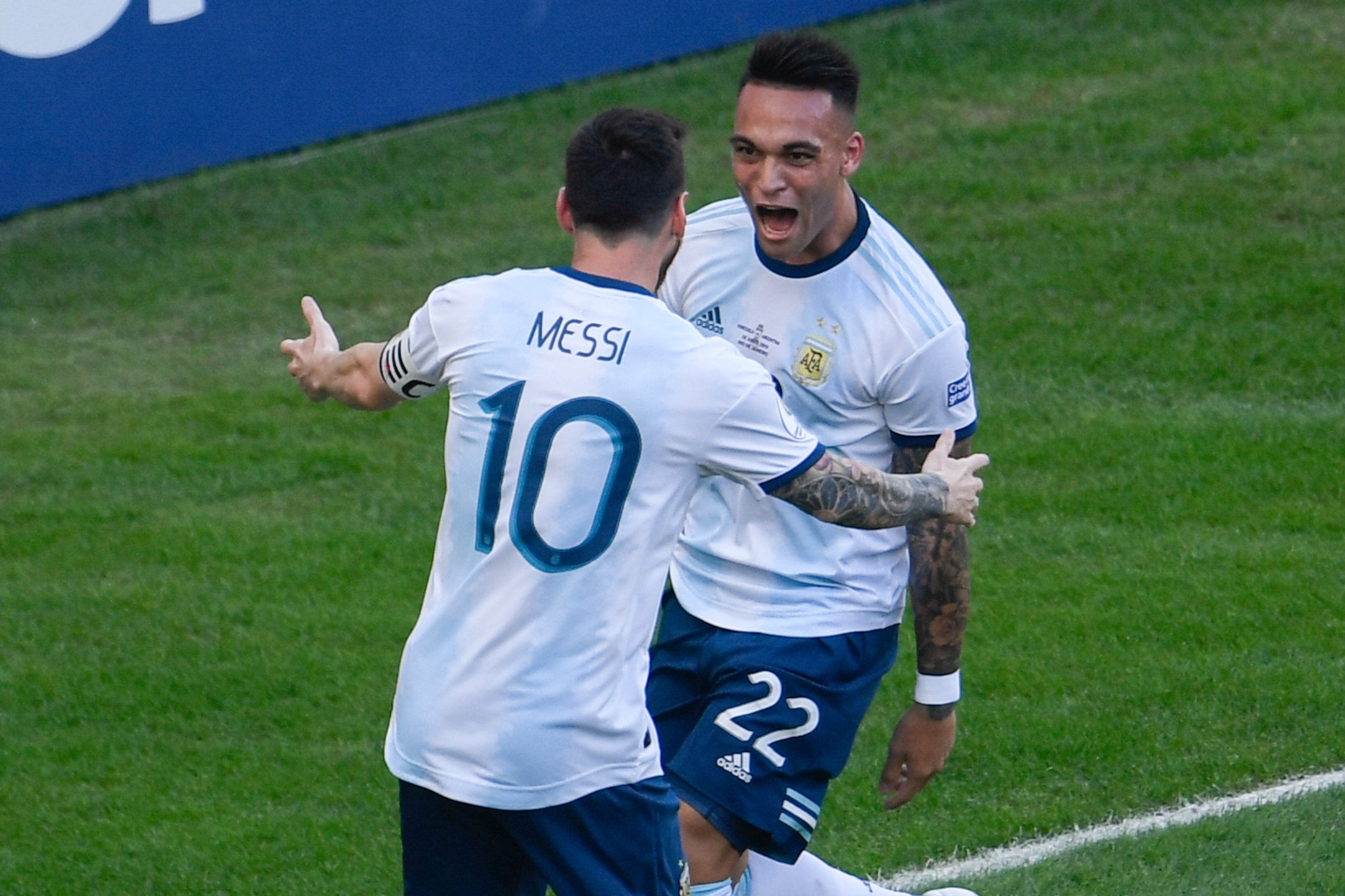 TOPSHOT - Argentina's Lautaro Martinez (R) celebrates with teammate Lionel Messi after scoring against Venezuela during their Copa America football tournament quarter-final match at Maracana Stadium in Rio de Janeiro, Brazil, on June 28, 2019. (Photo by M