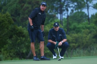 HOBE SOUND, FLORIDA - MAY 24:  Phil Mickelson reads a putt for NFL player Tom Brady of the Tampa Bay Buccaneers looks on the 17th green during The Match: Champions For Charity at Medalist Golf Club on May 24, 2020 in Hobe Sound, Florida. (Photo by Mike Eh