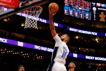 ATLANTA, GEORGIA - FEBRUARY 26:  Evan Fournier #10 of the Orlando Magic draws a foul as he drives against Cam Reddish #22 of the Atlanta Hawks in the second half at State Farm Arena on February 26, 2020 in Atlanta, Georgia.  NOTE TO USER: User expressly a