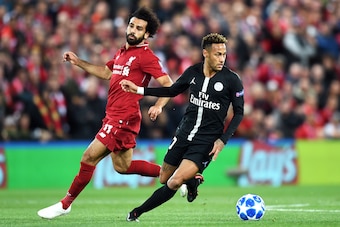 LIVERPOOL, ENGLAND - SEPTEMBER 18:  Neymar of Paris Saint-Germain runs with the ball under pressure from Mohamed Salah of Liverpool during the Group C match of the UEFA Champions League between Liverpool and Paris Saint-Germain at Anfield on September 18,