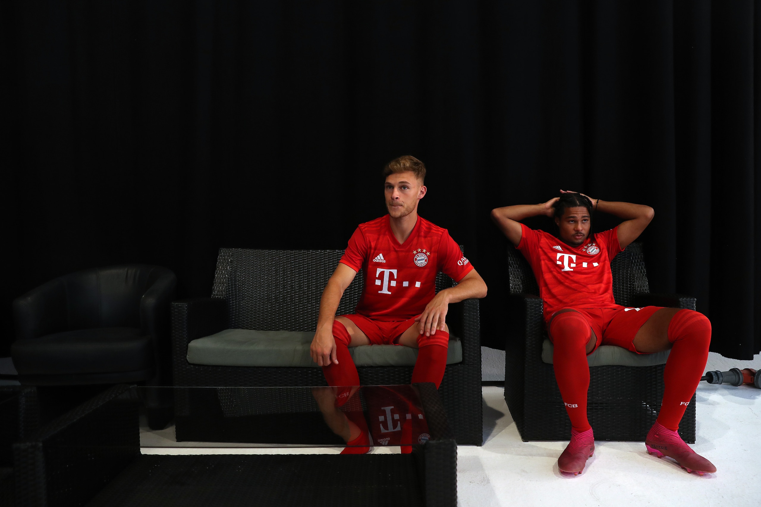 MUNICH, GERMANY - SEPTEMBER 01: Joshua Kimmich (L) of FC Bayern Muenchen and his team mate Serge Gnabry during the FC Bayern Muenchen and Paulaner photo session at FGV Schmidtle Studios on September 01, 2019 in Munich, Germany. (Photo by Alexander Hassens