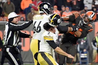 CLEVELAND, OHIO - NOVEMBER 14: Defensive end Myles Garrett #95 of the Cleveland Browns hits Quarterback Mason Rudolph #2 of the Pittsburgh Steelers over the head with his helmet during the second half in the game at FirstEnergy Stadium on November 14, 201