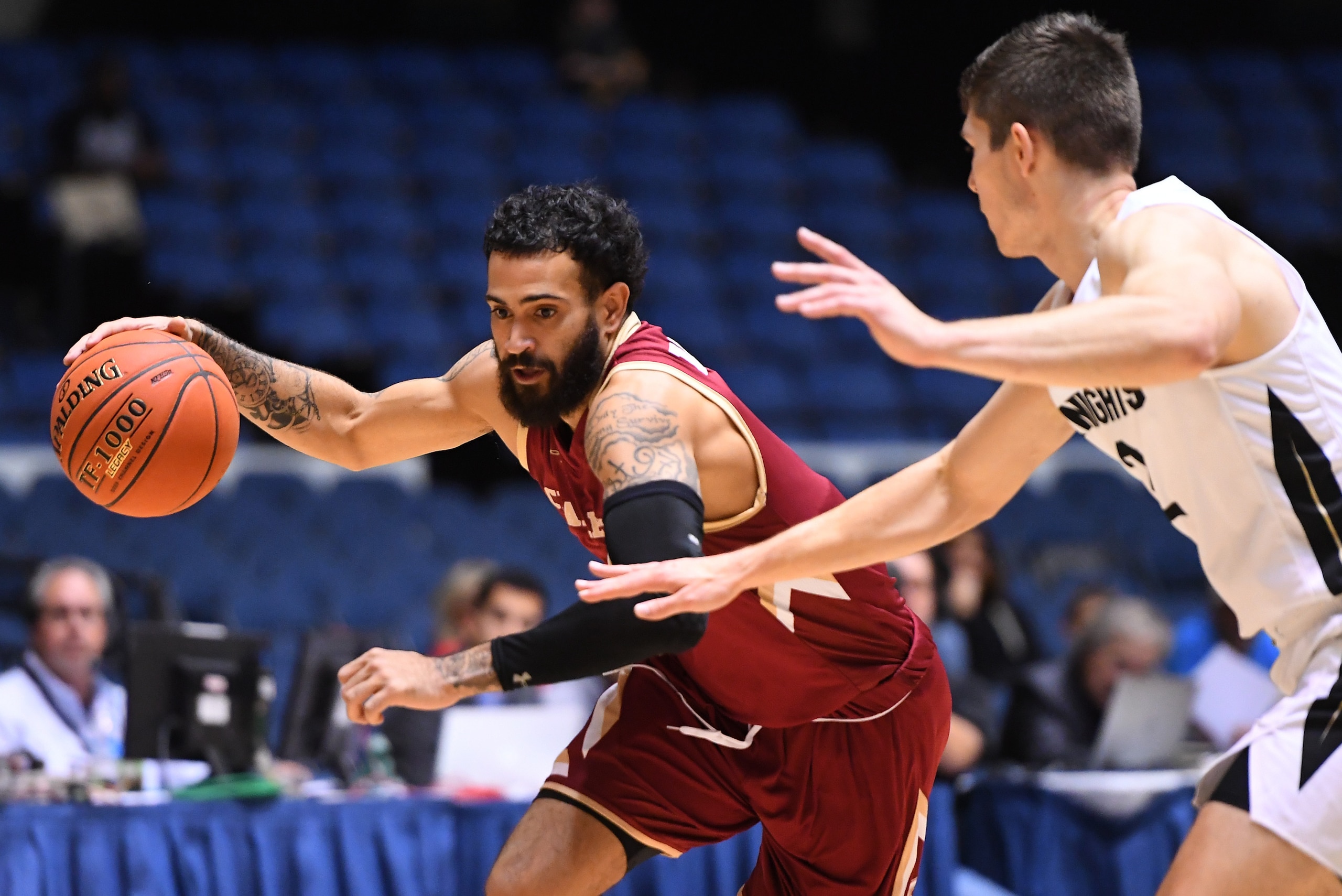 ANAHEIM, CA - DECEMBER 01:  Grant Riller #1 of the Charleston Cougars gets past Matt Milon #2 of the UCF Knights as he drives to the basket in the second half of the game during the Wooden Legacy at the Anaheim Convention Center at on December 1, 2019 in 