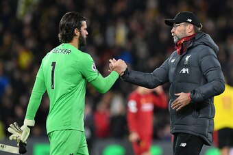 Liverpool's German manager Jurgen Klopp (R) reacts with Liverpool's Brazilian goalkeeper Alisson Becker at the final whistle during the English Premier League football match between Watford and Liverpool at Vicarage Road Stadium in Watford, north of Londo