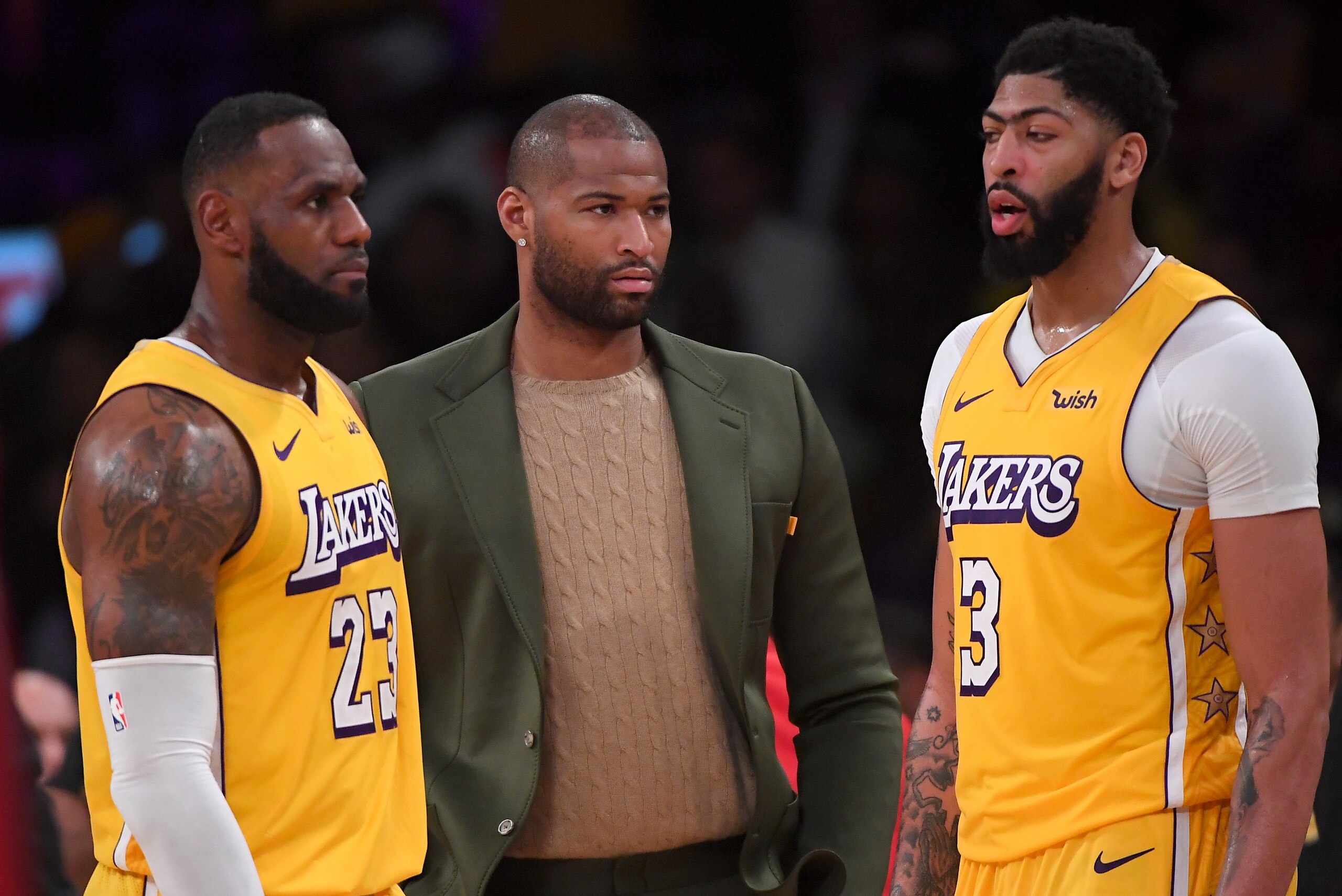 LOS ANGELES, CA - DECEMBER 25:  LeBron James #23 and Anthony Davis #3 talk with DeMarcus Cousins #15 of the Los Angeles Lakers on the bench during a time out in the game against the Los Angeles Clippers at Staples Center on December 25, 2019 in Los Angele