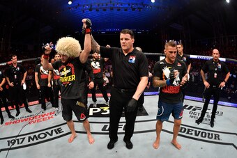 ABU DHABI, UNITED ARAB EMIRATES - SEPTEMBER 07:  (L-R) Khabib Nurmagomedov of Russia celebrates his submission victory over Dustin Poirier in their lightweight championship bout during UFC 242 at The Arena on September 7, 2019 in Yas Island, Abu Dhabi, Un