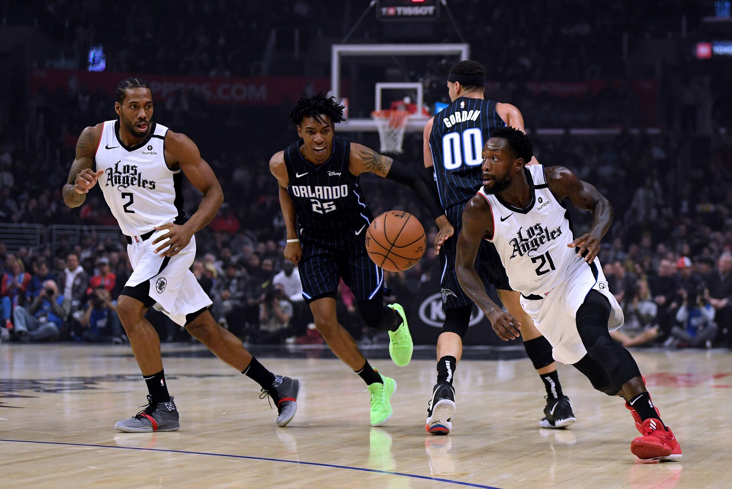 LOS ANGELES, CALIFORNIA - JANUARY 16:  Patrick Beverley #21 of the LA Clippers turns to the basket with Kawhi Leonard #2 as Wes Iwundu #25 of the Orlando Magic gives chase after a screen during the first half at Staples Center on January 16, 2020 in Los A