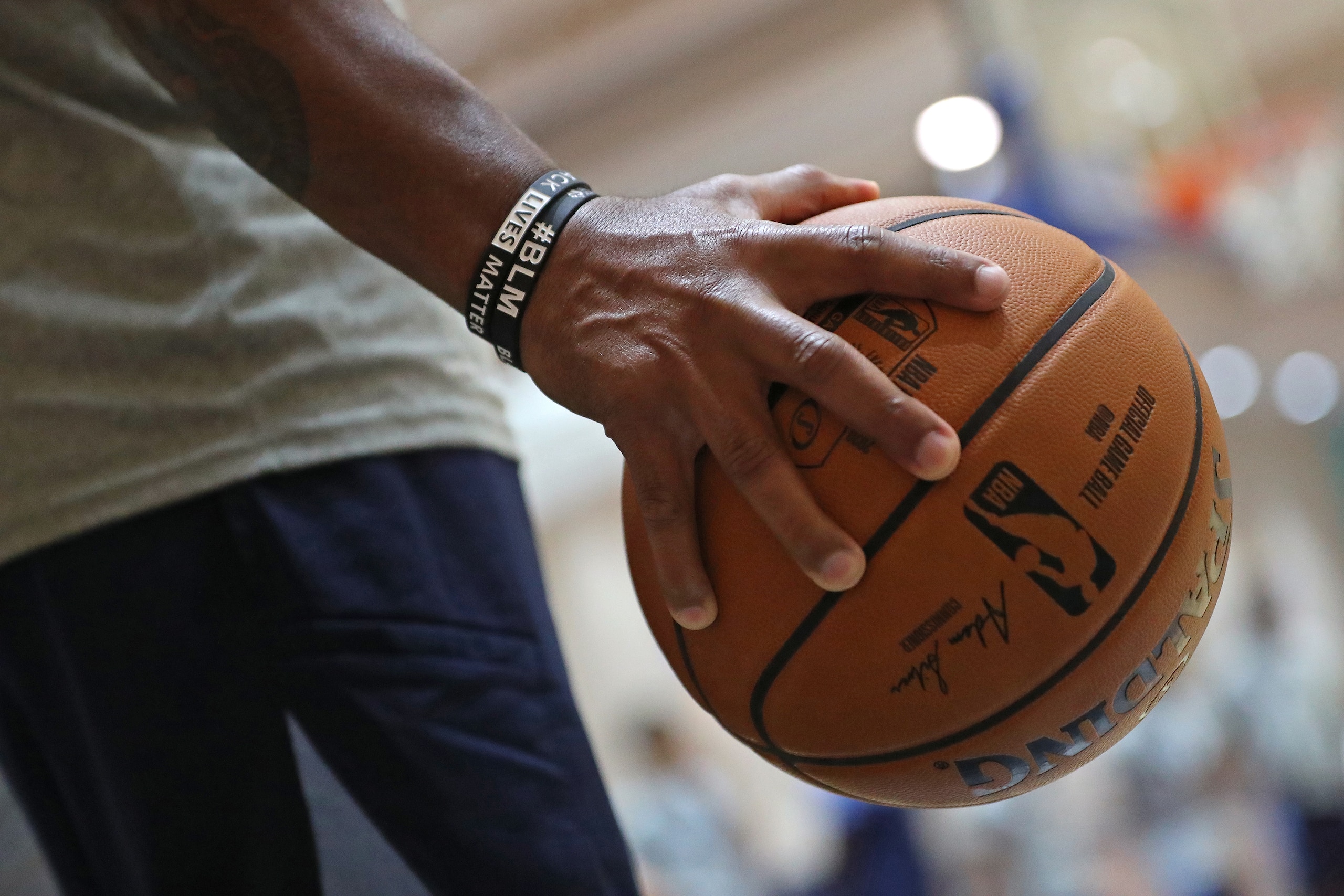 ORLANDO, FL - JULY 15: A generic basketball photo of a player holding the Official @NBA Spalding basketball held by Assistant Coach Scoonie Penn of the Memphis Grizzlies during practice as part of the NBA Restart 2020 on July 15, 2020 in Orlando, Florida. ORLANDO, FL - JULY 15: A generic basketball photo of a player holding the Official @NBA Spalding basketball held by Assistant Coach Scoonie Penn of the Memphis Grizzlies during practice as part of the NBA Restart 2020 on July 15, 2020 in Orlando, Florida.