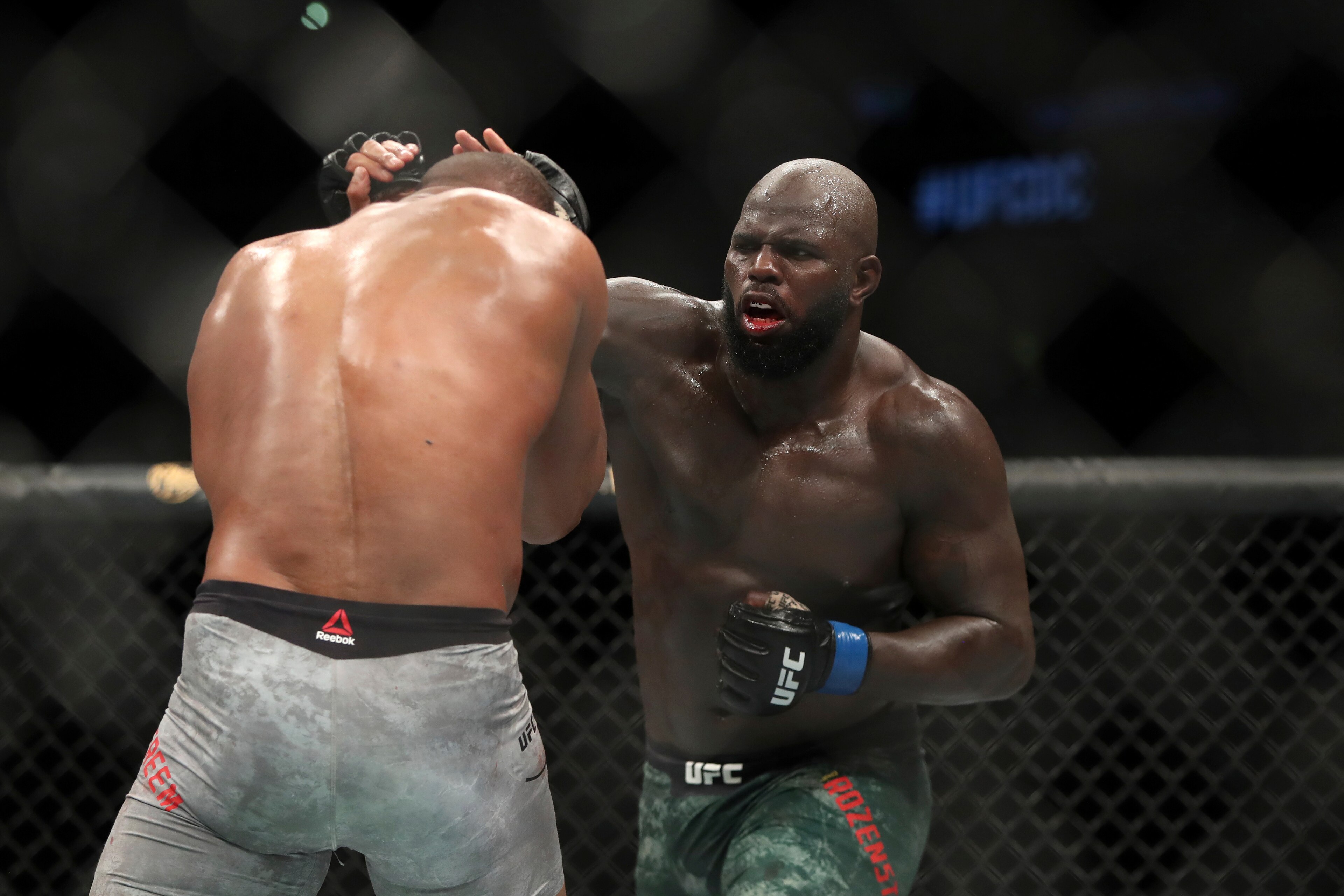 Rozenstruik (right) hits Alistair Overeem Rozenstruik (right) hits Alistair Overeem