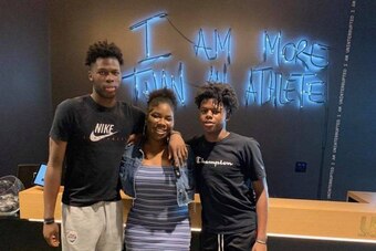 Chris Livingston (left) stands in the Uninterrupted offices with siblings Cydnee and Cordell.