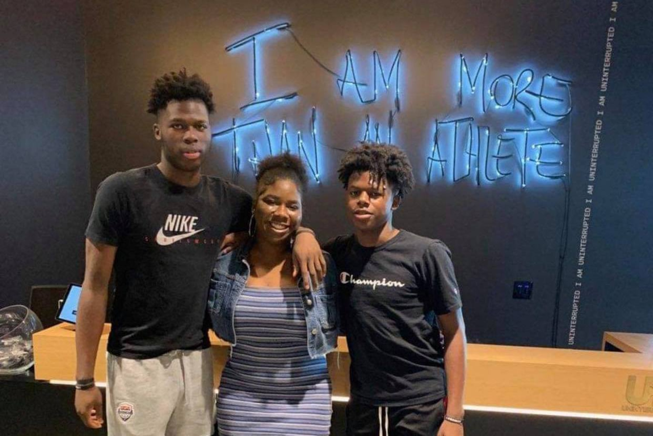 Chris Livingston (left) stands in the Uninterrupted offices with siblings Cydnee and Cordell.
