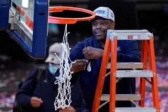 Patrick Ewing cuts down the net.