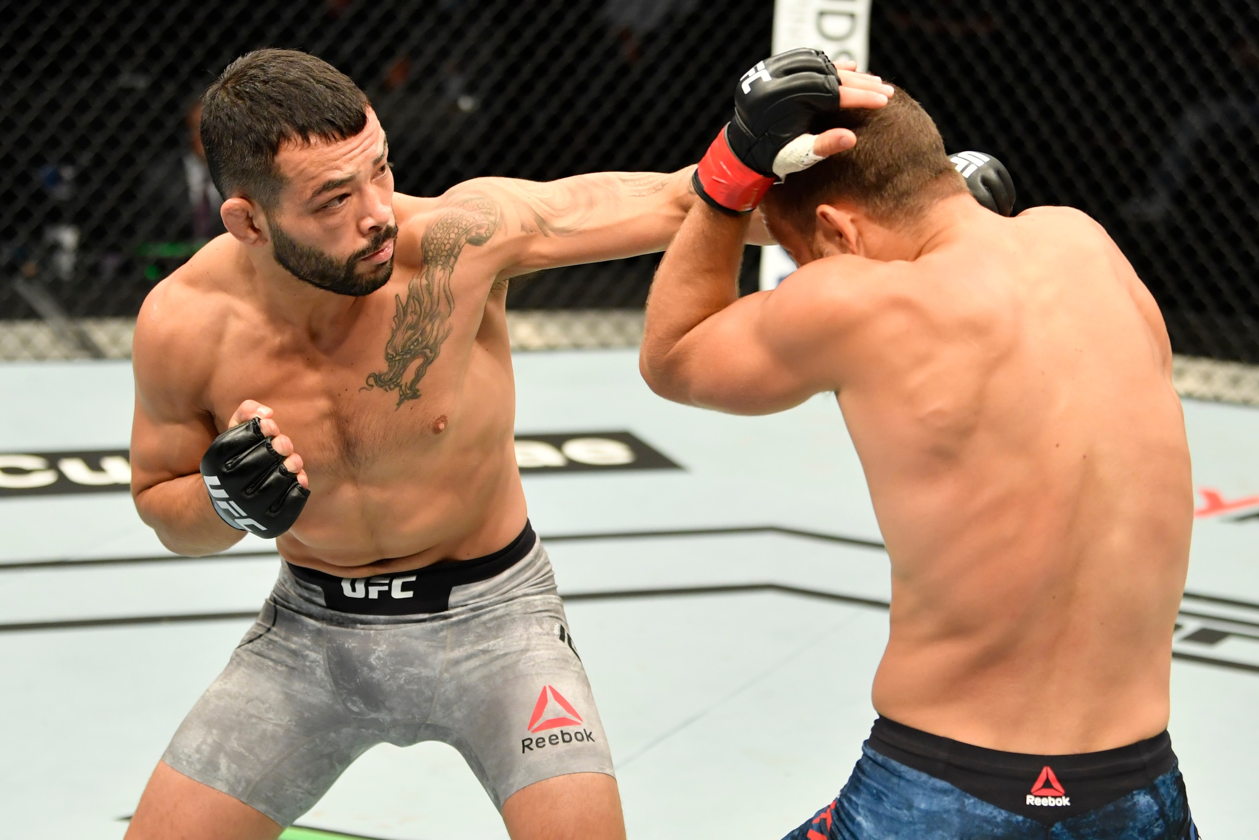 ABU DHABI, UNITED ARAB EMIRATES - JULY 16: In this handout image provided by UFC, (L-R) Dan Ige punches Calvin Kattar in their featherweight fight during the UFC Fight Night event inside Flash Forum on UFC Fight Island on July 16, 2020 in Yas Island, Abu 