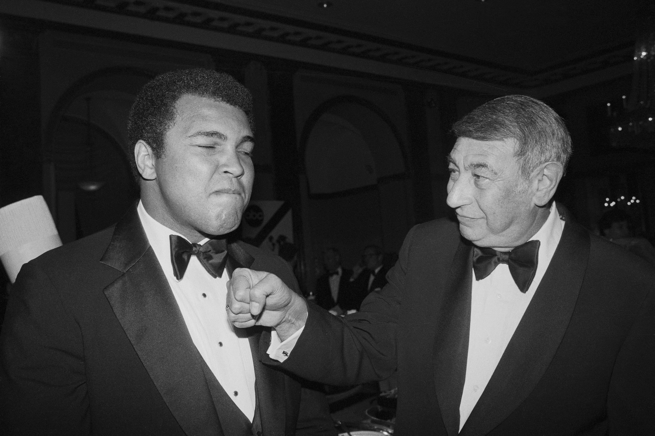 (Original Caption) Sportscaster Howard Cosell playfully socks former heavyweight champ Muhammad Ali in this photograph, during a dinner celebrating the 20th anniversary of ABC-TV's Wide World of Sports. The affair was held at the Waldorf-Astoria.