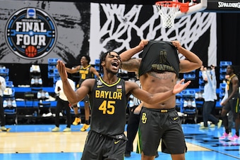 INDIANAPOLIS, INDIANA - APRIL 05: Davion Mitchell #45 and Mark Vital #11 of the Baylor Bears celebrate their win against the Gonzaga Bulldogs in the National Championship game of the 2021 NCAA Men's Basketball Tournament at Lucas Oil Stadium on April 05, 