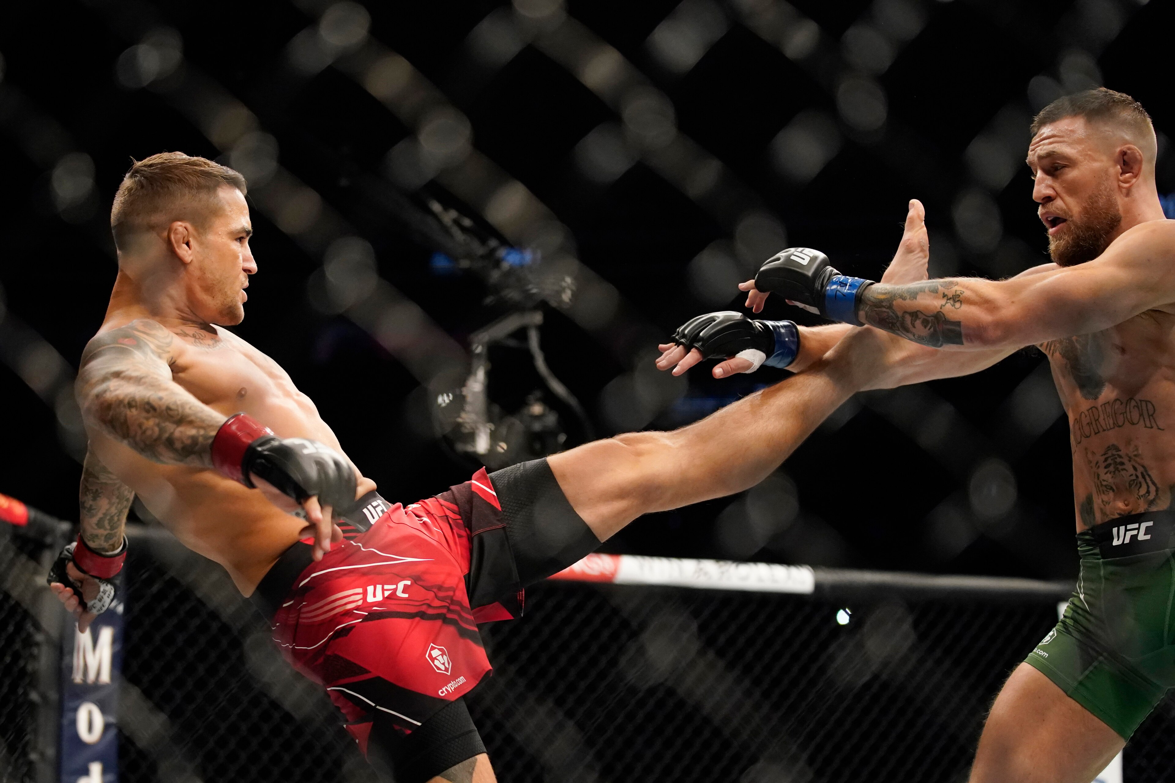 Dustin Poirier (left) kicks McGregor Dustin Poirier (left) kicks McGregor