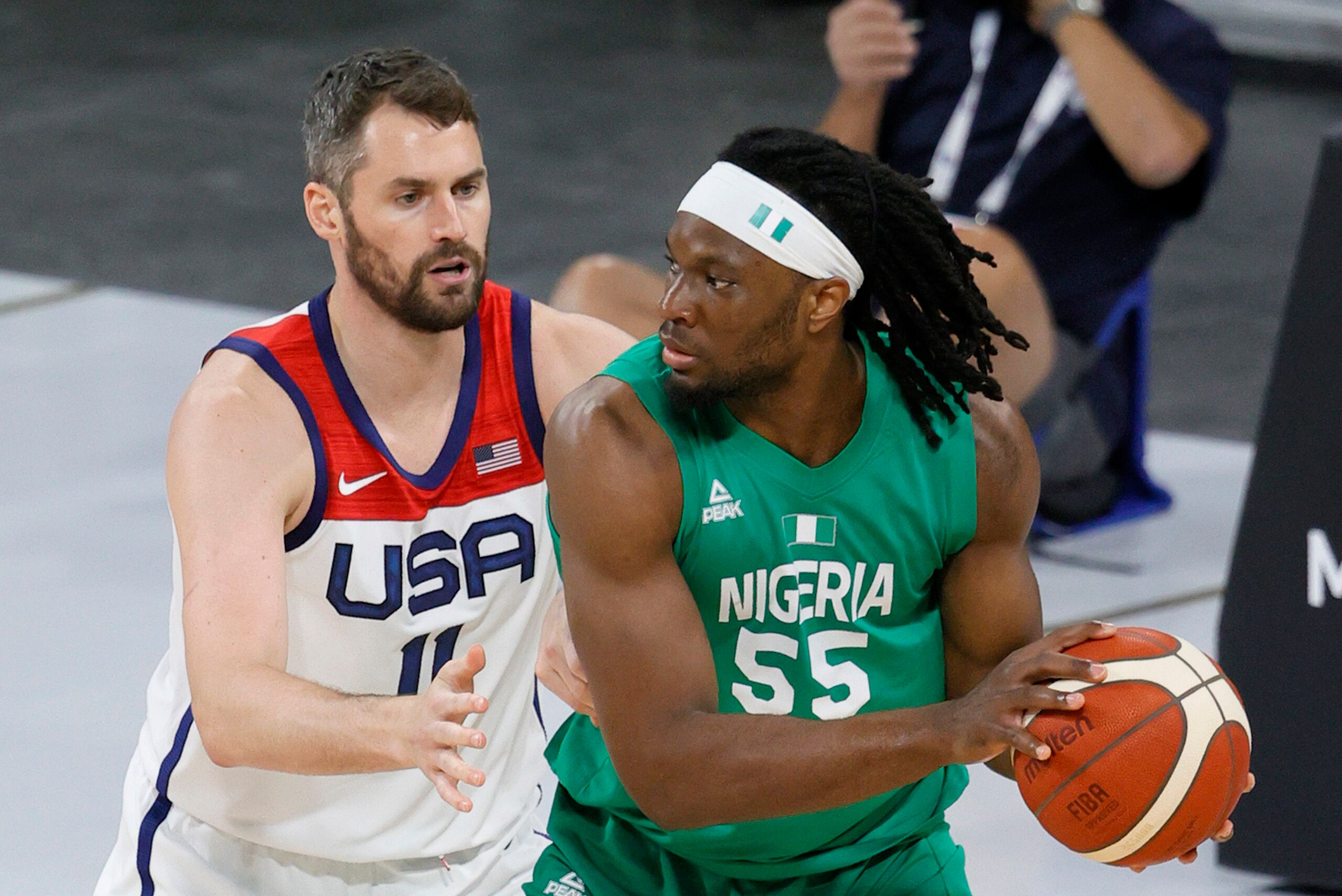 LAS VEGAS, NEVADA - JULY 10:  Precious Achiuwa #55 of Nigeria is guarded by Kevin Love #11 of the United States during an exhibition game at Michelob ULTRA Arena ahead of the Tokyo Olympic Games on July 10, 2021 in Las Vegas, Nevada. Nigeria defeated the 