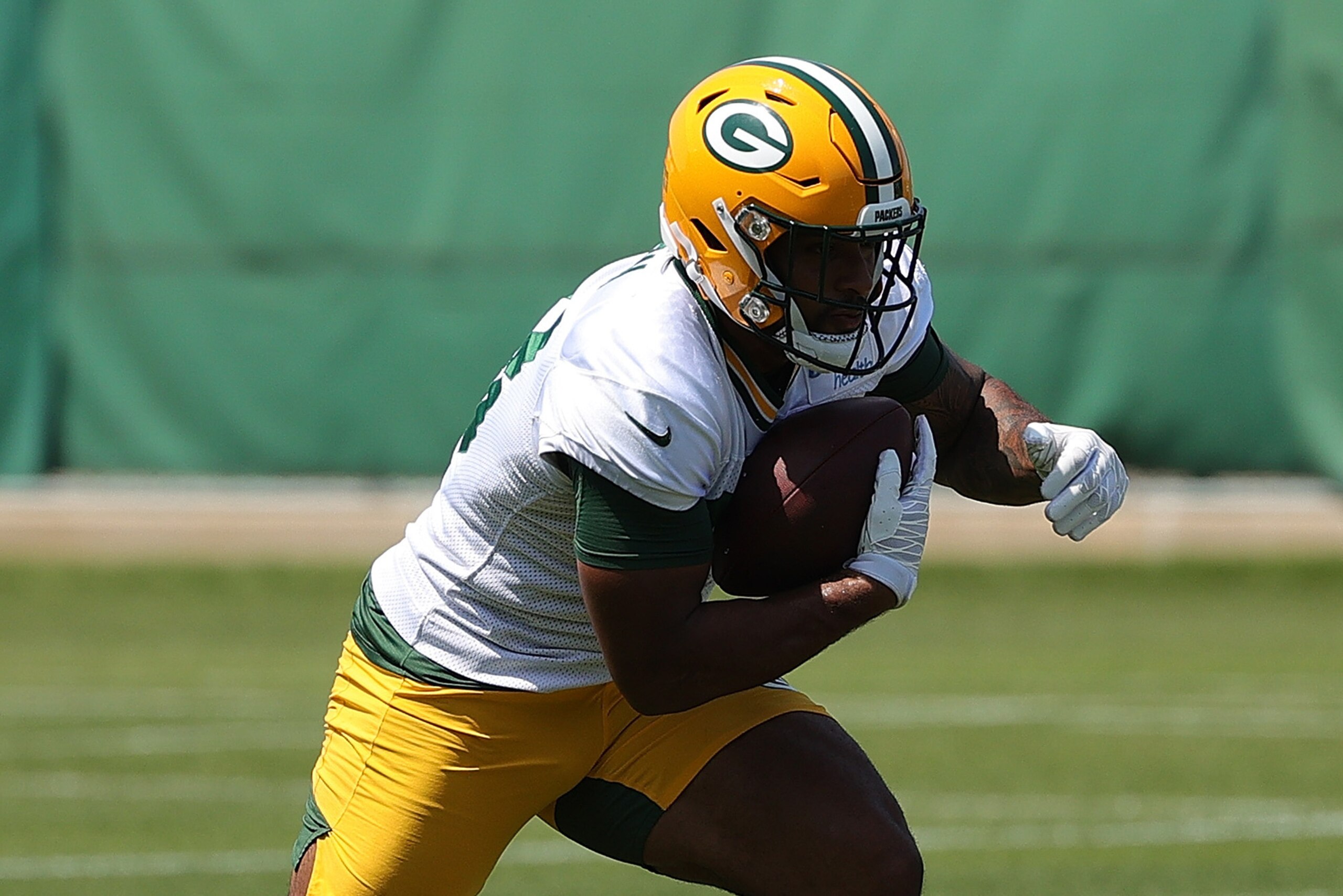 ASHWAUBENON, WISCONSIN - JUNE 09: A.J. Dillon #28 of the Green Bay Packers works out during training camp at Ray Nitschke Field on June 09, 2021 in Ashwaubenon, Wisconsin. (Photo by Stacy Revere/Getty Images)