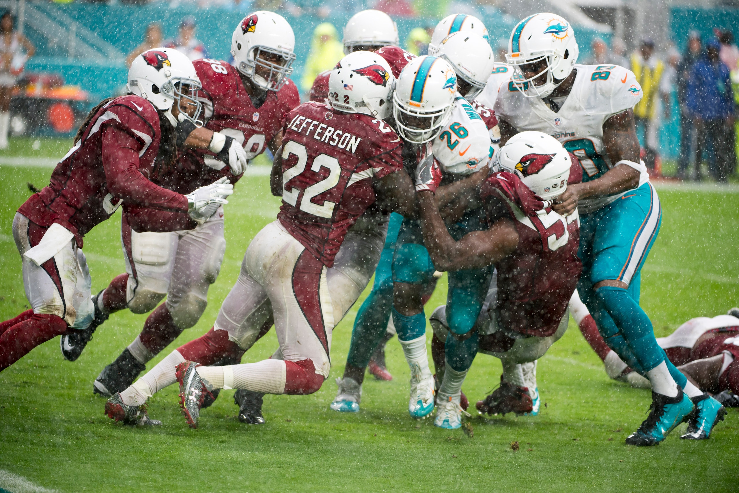 MIAMI GARDENS, FL - DECEMBER 11: Miami Dolphins Running Back Damien Williams (26) runs with ball and is tackled by Arizona Cardinals Linebacker Chandler Jones (55), Arizona Cardinals Linebacker Sio Moore (54), Arizona Cardinals Safety Tony Jefferson (22) 