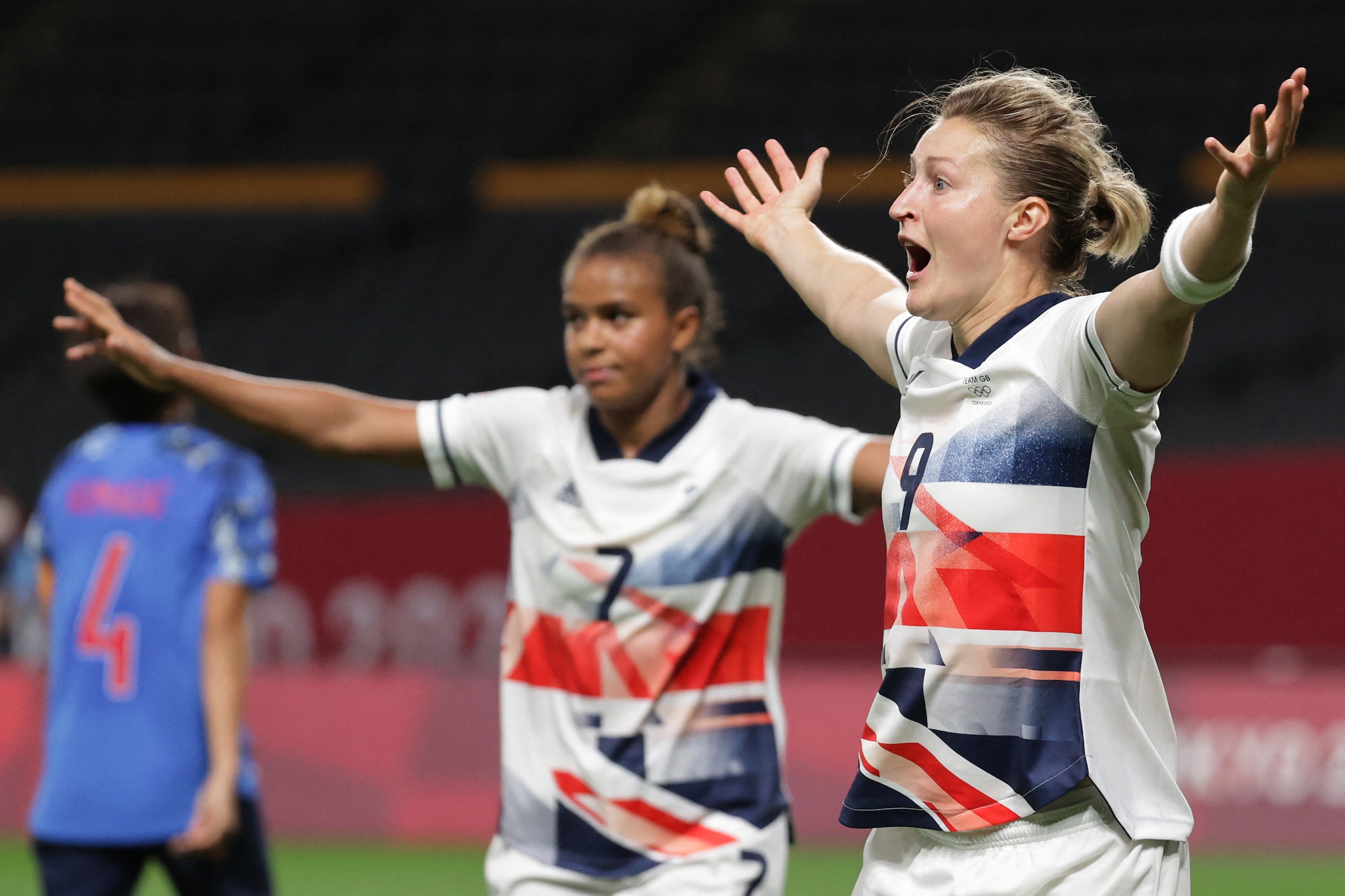 Britain's forward Ellen White (R) celebrates after scoring a goal during the Tokyo 2020 Olympic Games women's group E first round football match between Japan and Britain at the Sapporo Dome in Sapporo on July 24, 2021. (Photo by ASANO IKKO / AFP) (Photo 