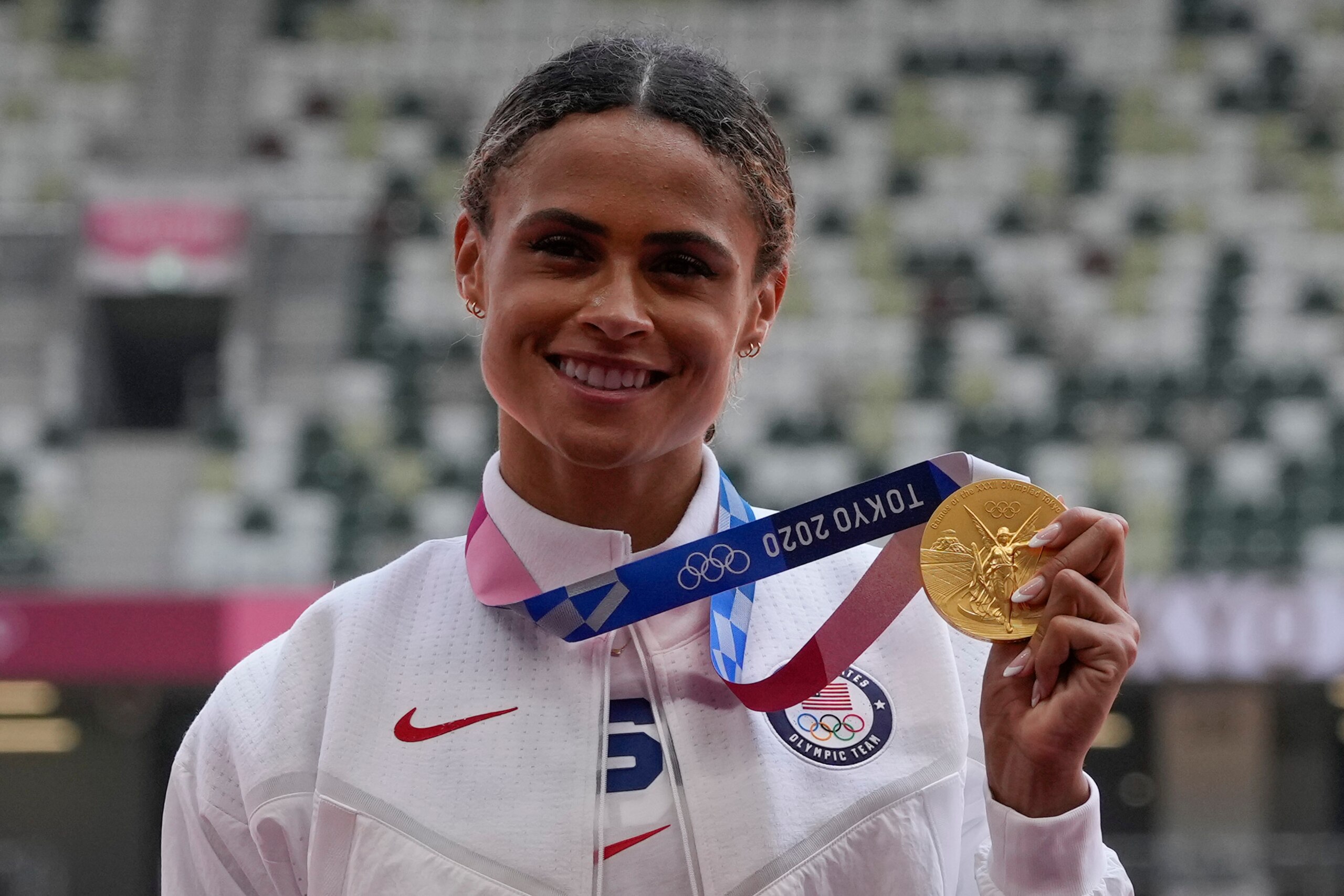 McLaughlin shows her gold medal earned during her record-setting race. McLaughlin shows her gold medal earned during her record-setting race.