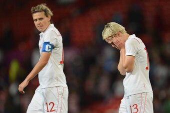 Sinclair and teammate Sophie Schmidt after Canada's loss to the U.S. at the 2012 Olympics.