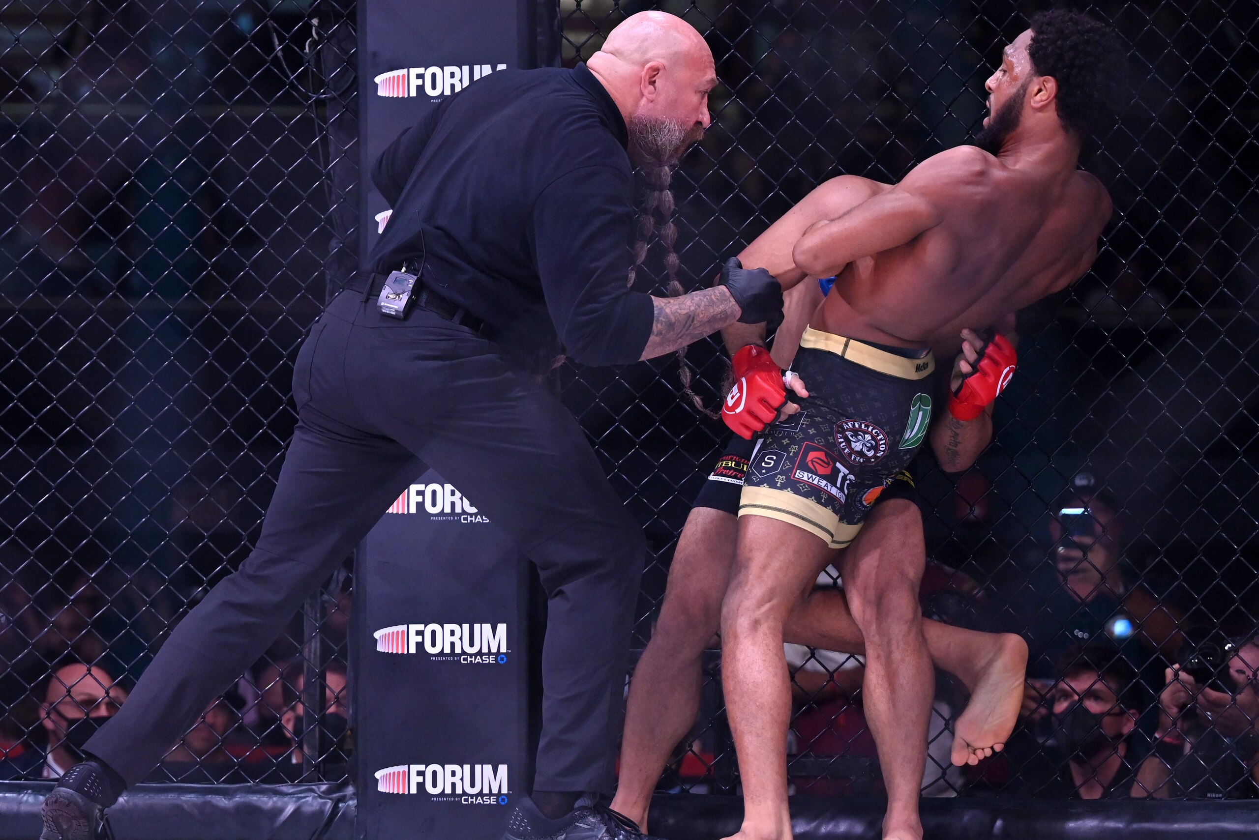 INGLEWOOD, CA - JULY 31:  AJ McKee (blue gloves) as he defeats Patricio Pitbull (red gloves) by first round submission in their Featherweight World Title Main Event fight at The Forum on July 31, 2021 in Inglewood, California. (Photo by Jayne Kamin-Oncea/