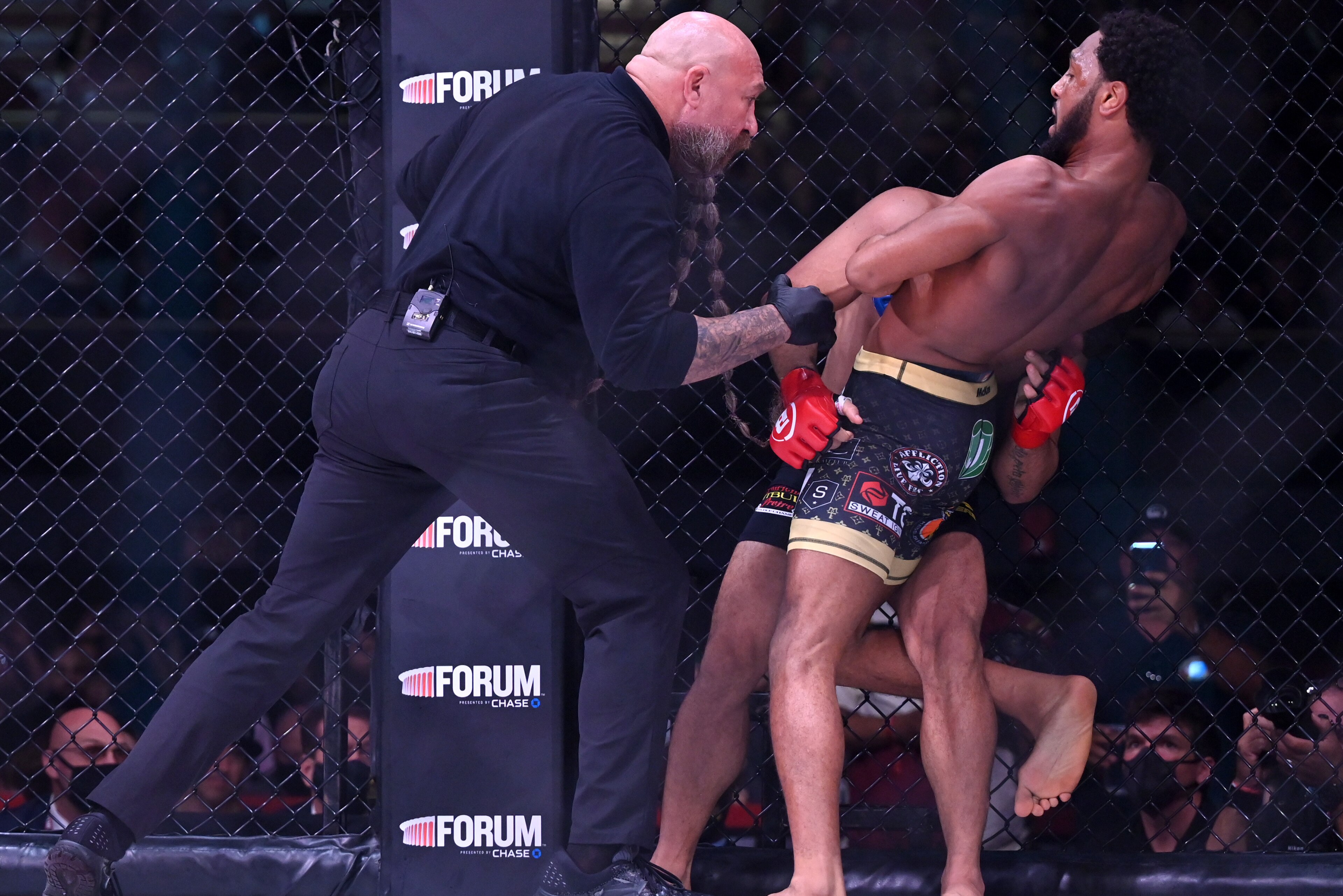 INGLEWOOD, CA - JULY 31:  AJ McKee (blue gloves) as he defeats Patricio Pitbull (red gloves) by first round submission in their Featherweight World Title Main Event fight at The Forum on July 31, 2021 in Inglewood, California. (Photo by Jayne Kamin-Oncea/