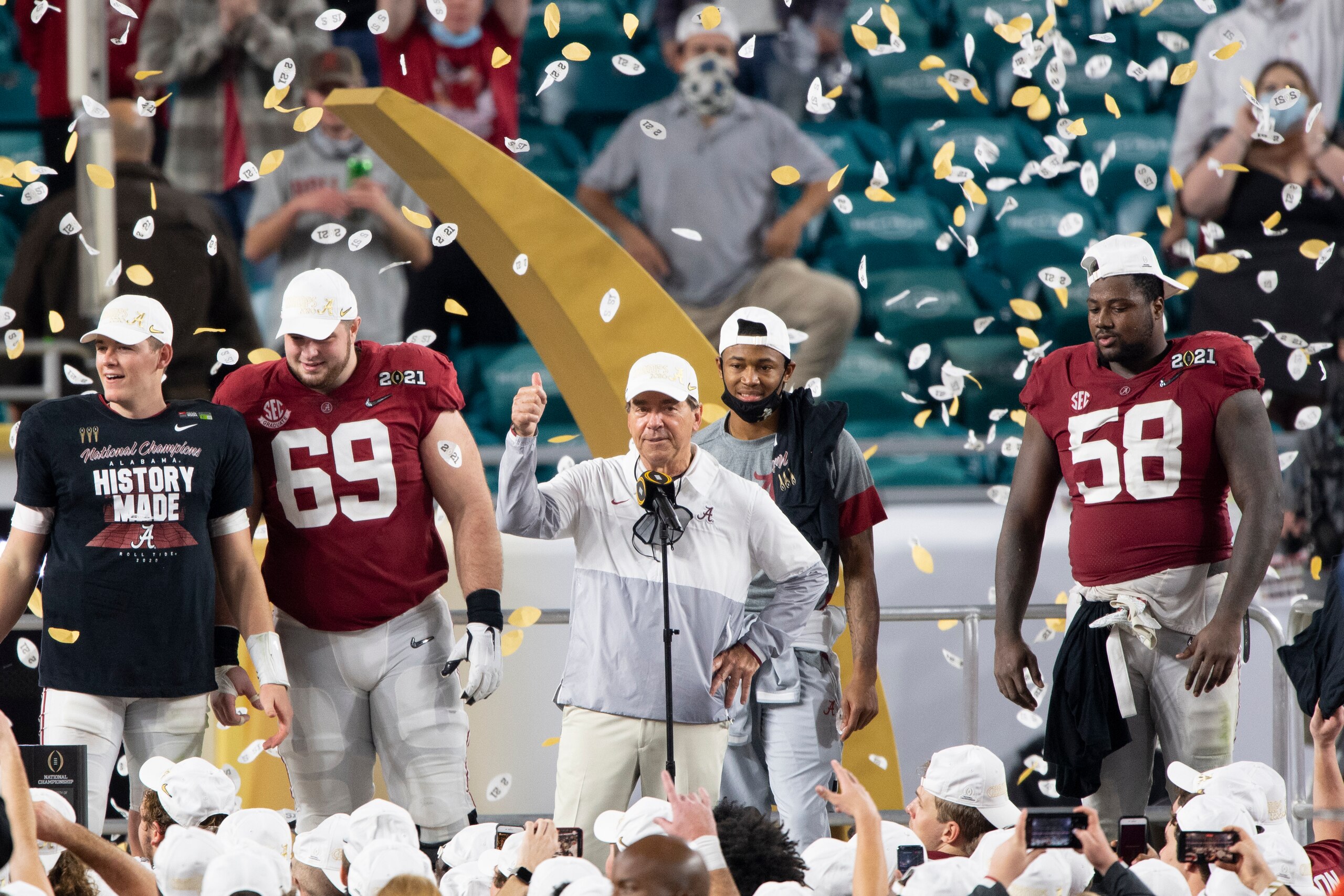 MIAMI GARDENS, FL - JANUARY 11: Alabama Crimson Tide head coach Nick Saban gives a thumbs up as he celebrates on the stage with Alabama Crimson Tide quarterback Mac Jones (left), Alabama Crimson Tide offensive lineman Landon Dickerson (69), Alabama Crimso
