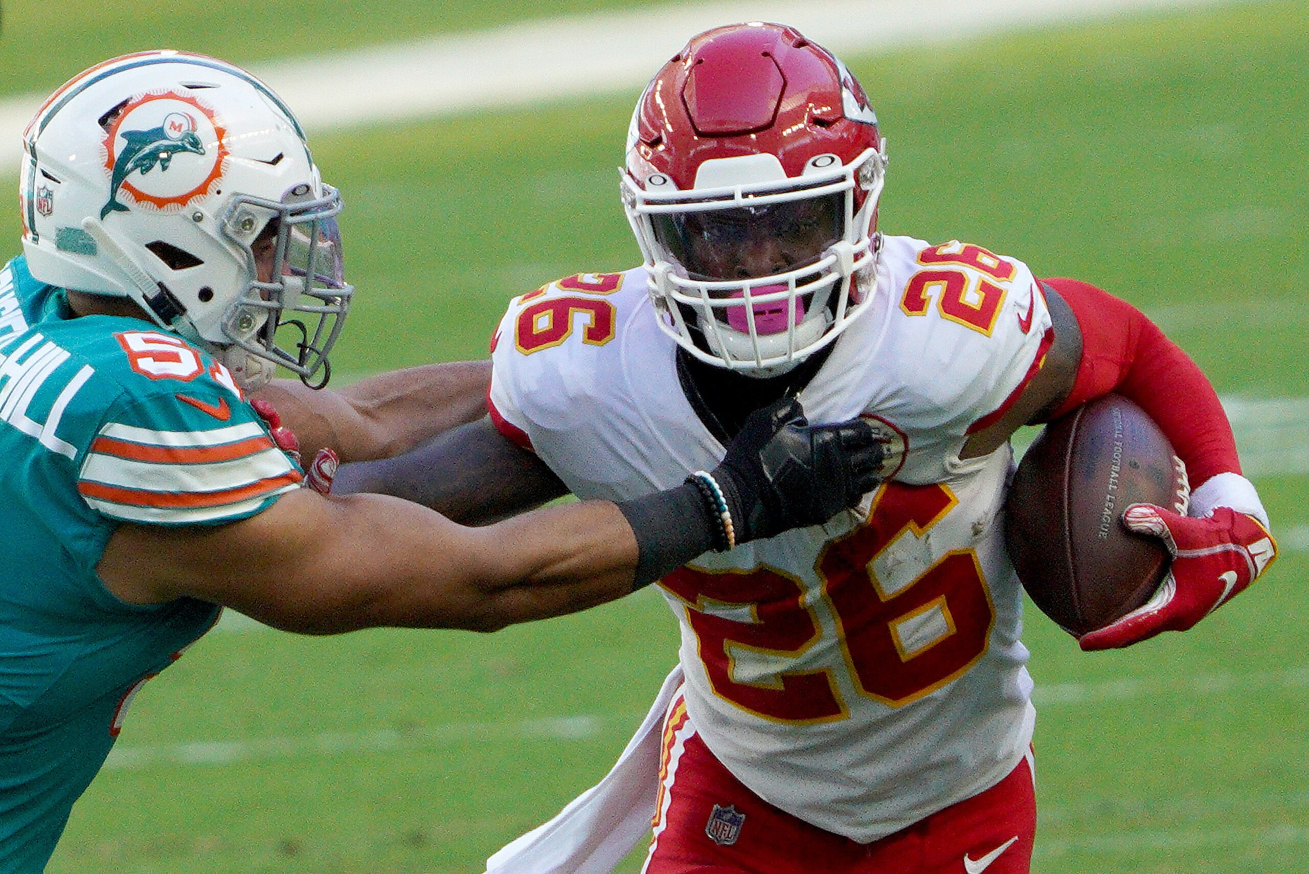MIAMI GARDENS, FLORIDA - DECEMBER 13: Le'Veon Bell #26 of the Kansas City Chiefs carries the ball against Kamu Grugier-Hill #51 of the Miami Dolphins during the first half of the game at Hard Rock Stadium on December 13, 2020 in Miami Gardens, Florida. (P