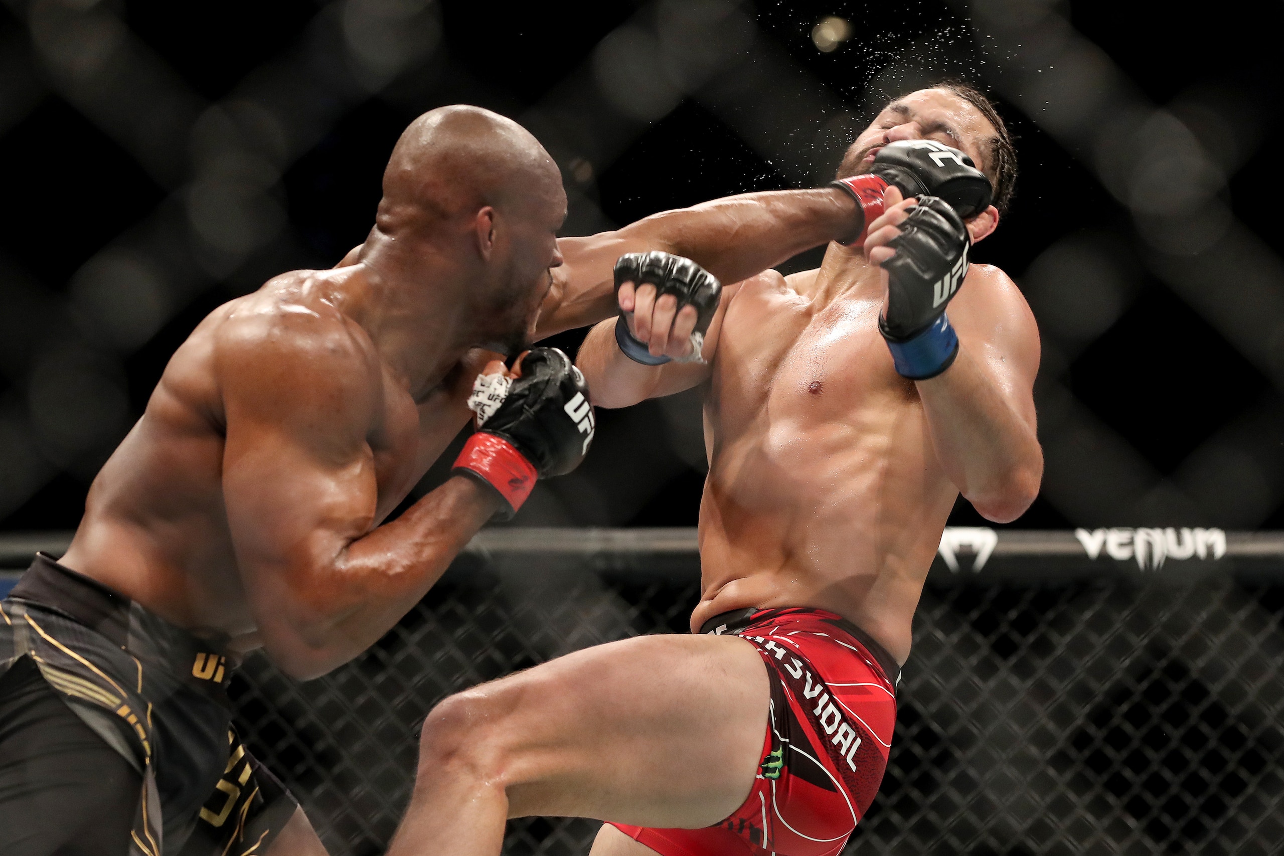 JACKSONVILLE, FL - APRIL 25: Kamaru Usman of Nigeria punches Jorge Masvidal of the United States during the Welterweight Title bout of UFC 261 at VyStar Veterans Memorial Arena on April 25, 2021 in Jacksonville, Florida.  (Photo by Alex Menendez/Getty Ima