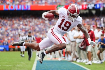 GAINESVILLE, FLORIDA - SEPTEMBER 18: Jahleel Billingsley #19 of the Alabama Crimson Tide scores a touchdown during the first quarter of a game against the Florida Gators at Ben Hill Griffin Stadium on September 18, 2021 in Gainesville, Florida. (Photo by 