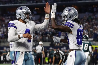 ARLINGTON, TEXAS - SEPTEMBER 27: CeeDee Lamb #88 of the Dallas Cowboys celebrates his second half touchdown with Dak Prescott #4 while playing the Philadelphia Eagles at AT&T Stadium on September 27, 2021 in Arlington, Texas. (Photo by Tom Pennington/Gett