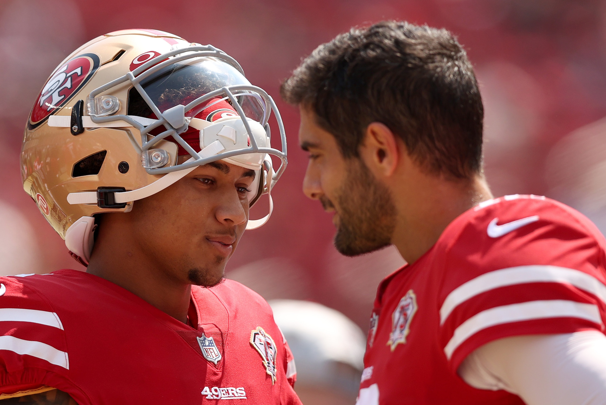 SANTA CLARA, CALIFORNIA - AUGUST 29: Jimmy Garoppolo #10 and Trey Lance #5 of the San Francisco 49ers talk to each other on the sidelines before their preseason game against the Las Vegas Raiders at Levi's Stadium on August 29, 2021 in Santa Clara, Califo