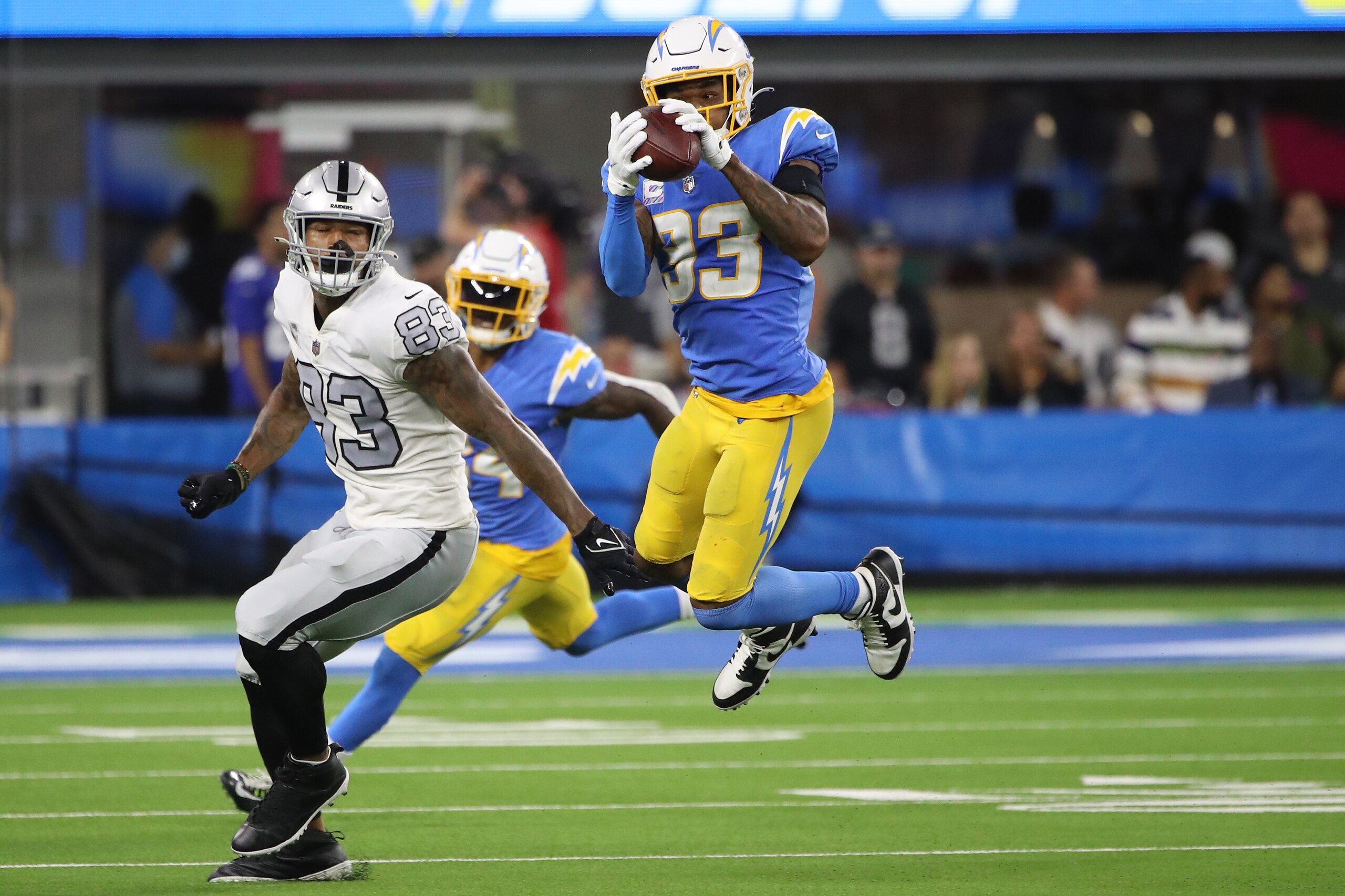 INGLEWOOD, CALIFORNIA - OCTOBER 04: Free safety Derwin James #33 of the Los Angeles Chargers intercepts a pass intended for tight end Darren Waller #83 of the Las Vegas Raiders during the fourth quarter at SoFi Stadium on October 4, 2021 in Inglewood, Cal