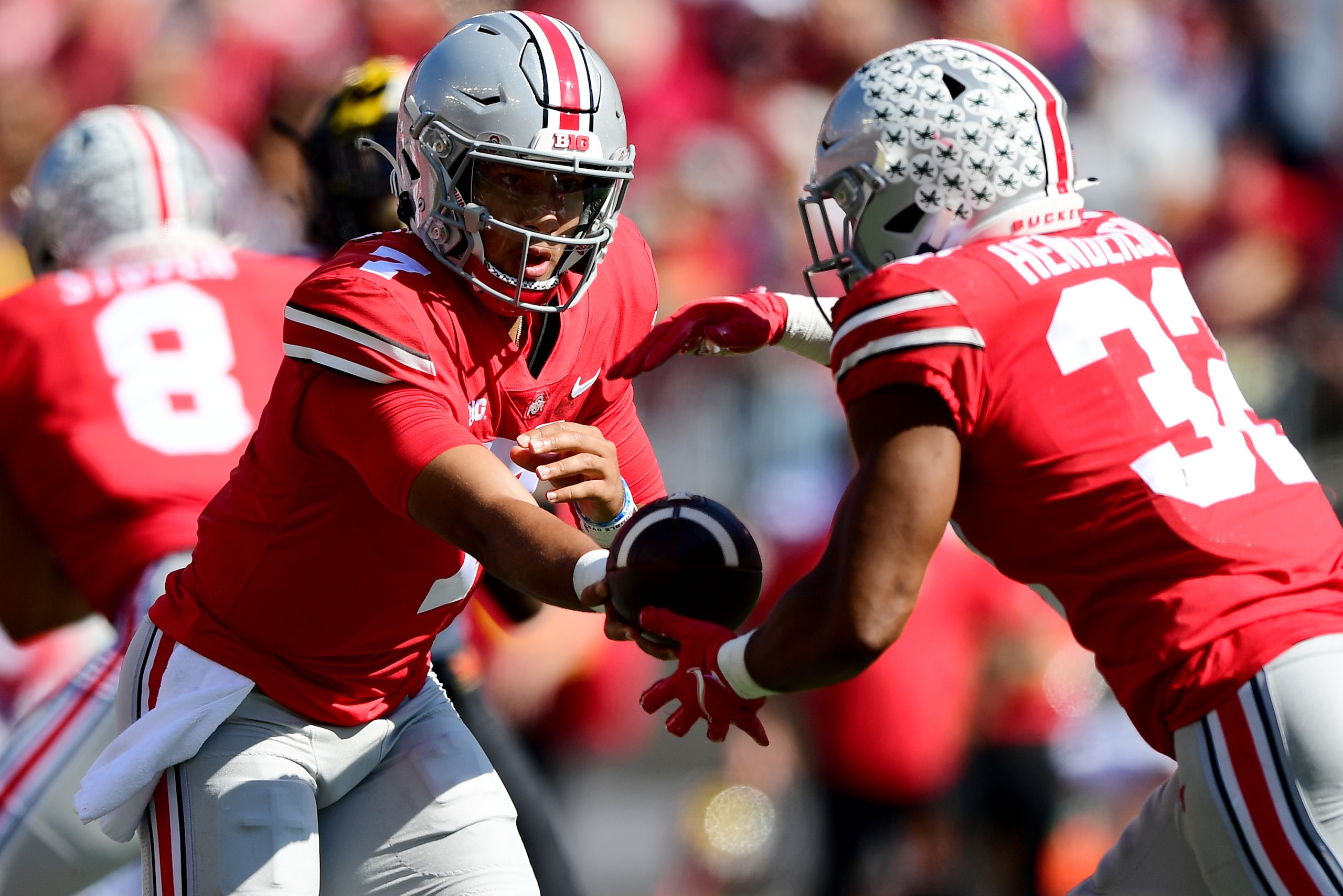 COLUMBUS, OHIO - OCTOBER 09: C.J. Stroud #7 of the Ohio State Buckeyes hands the ball off to TreVeyon Henderson #32 in the first quarter during a game against the Maryland Terrapins at Ohio Stadium on October 09, 2021 in Columbus, Ohio. (Photo by Emilee C