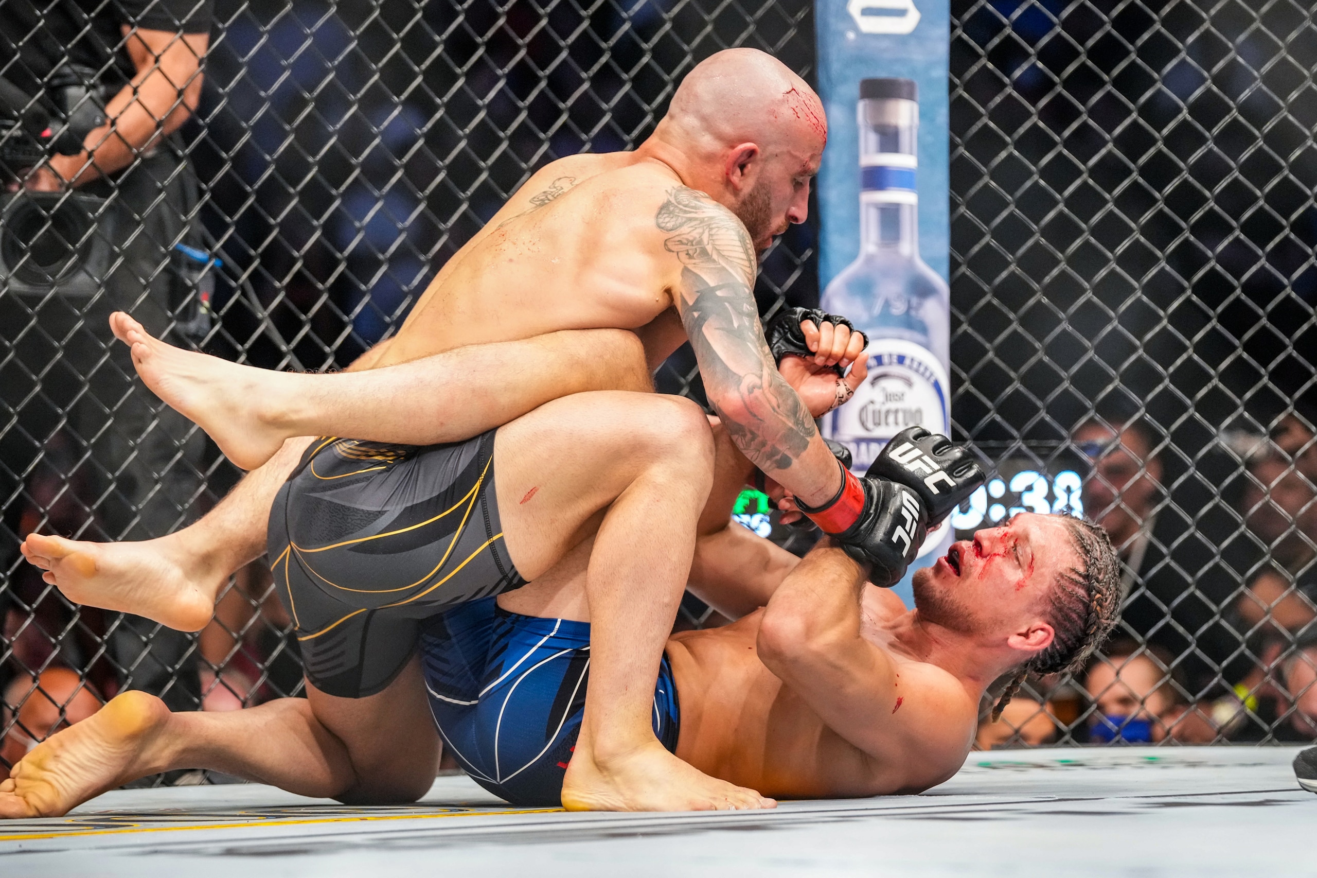 LAS VEGAS, NV - SEPTEMBER 25: (L-R) Alexander Volkanovski grapples with Brian Ortega in their featherweight fight during UFC 266 on September 25, 2021, at T-Mobile Arena in Las Vegas, NV. (Photo by Louis Grasse/PxImages/Icon Sportswire via Getty Images)