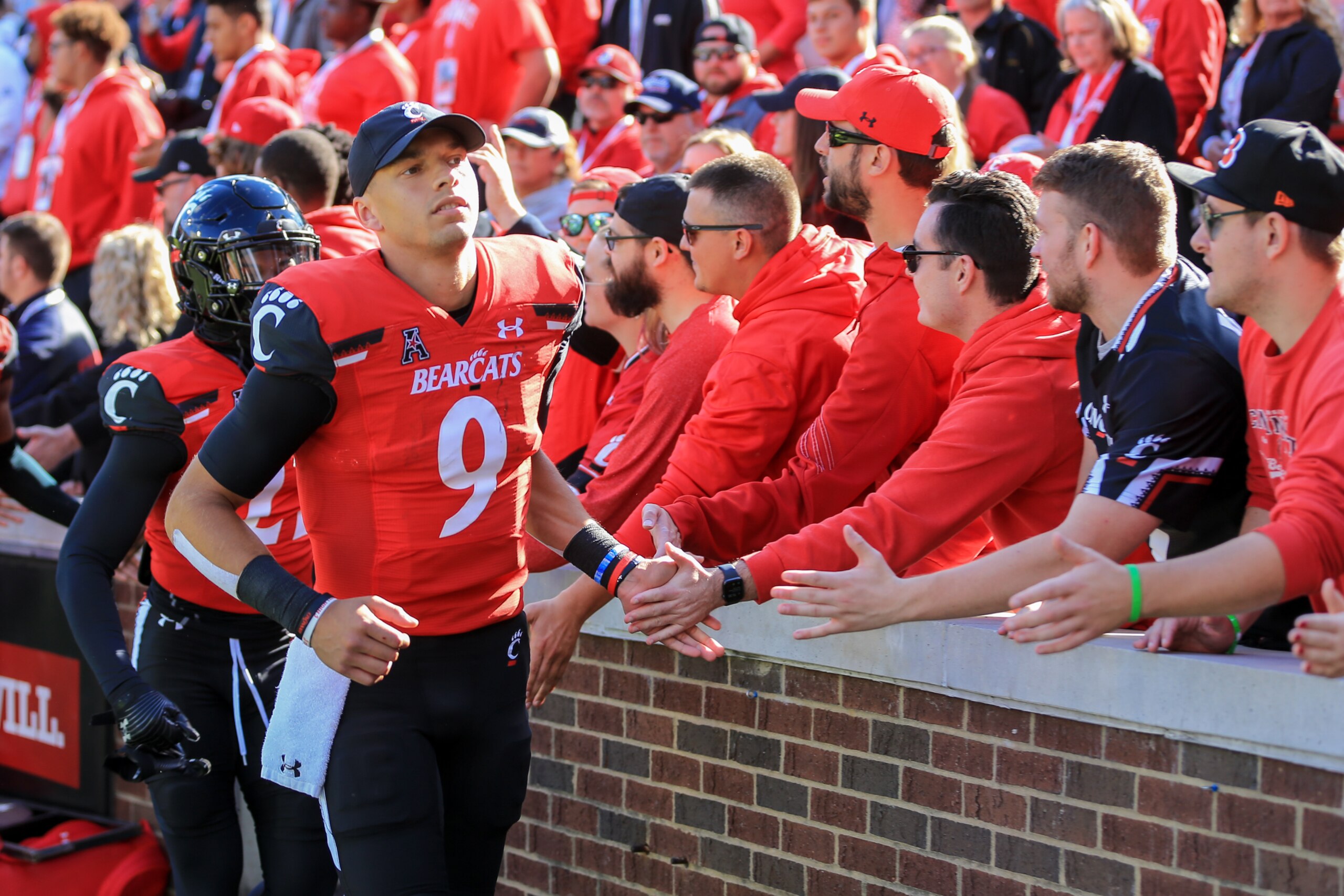 CINCINNATI, OH - OCTOBER 16: Cincinnati Bearcats quarterback Desmond Ridder (9) high-fives fans after the game against the UCF Knights and the Cincinnati Bearcats on October 16, 2021, at Nippert Stadium in Cincinnati, OH. (Photo by Ian Johnson/Icon Sports CINCINNATI, OH - OCTOBER 16: Cincinnati Bearcats quarterback Desmond Ridder (9) high-fives fans after the game against the UCF Knights and the Cincinnati Bearcats on October 16, 2021, at Nippert Stadium in Cincinnati, OH. (Photo by Ian Johnson/Icon Sports