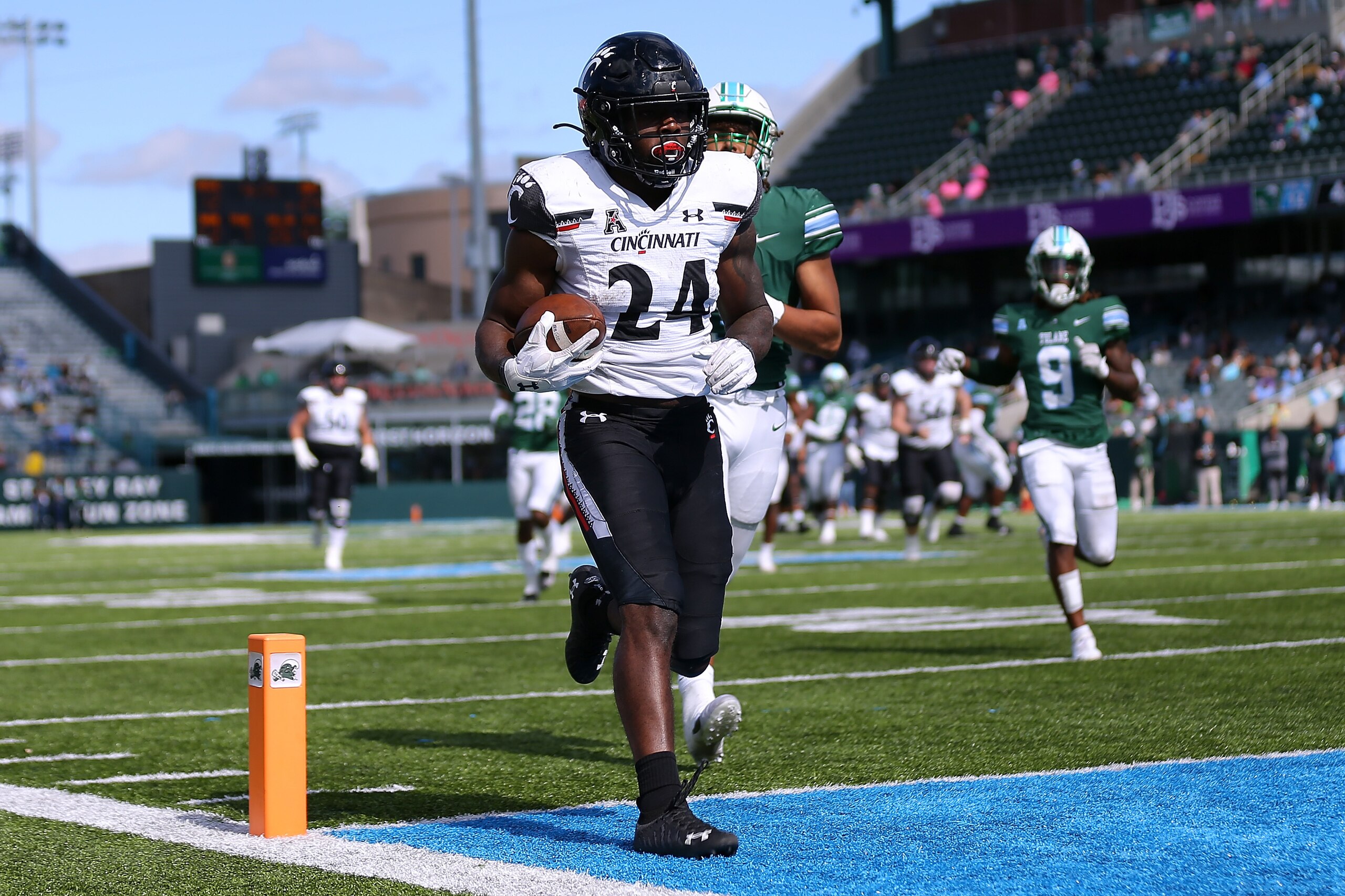 NEW ORLEANS, LOUISIANA - OCTOBER 30: Jerome Ford #24 of the Cincinnati Bearcats rushes for a touchdown as Angelo Anderson #3 of the Tulane Green Wave defends during the second half at Yulman Stadium on October 30, 2021 in New Orleans, Louisiana. (Photo by