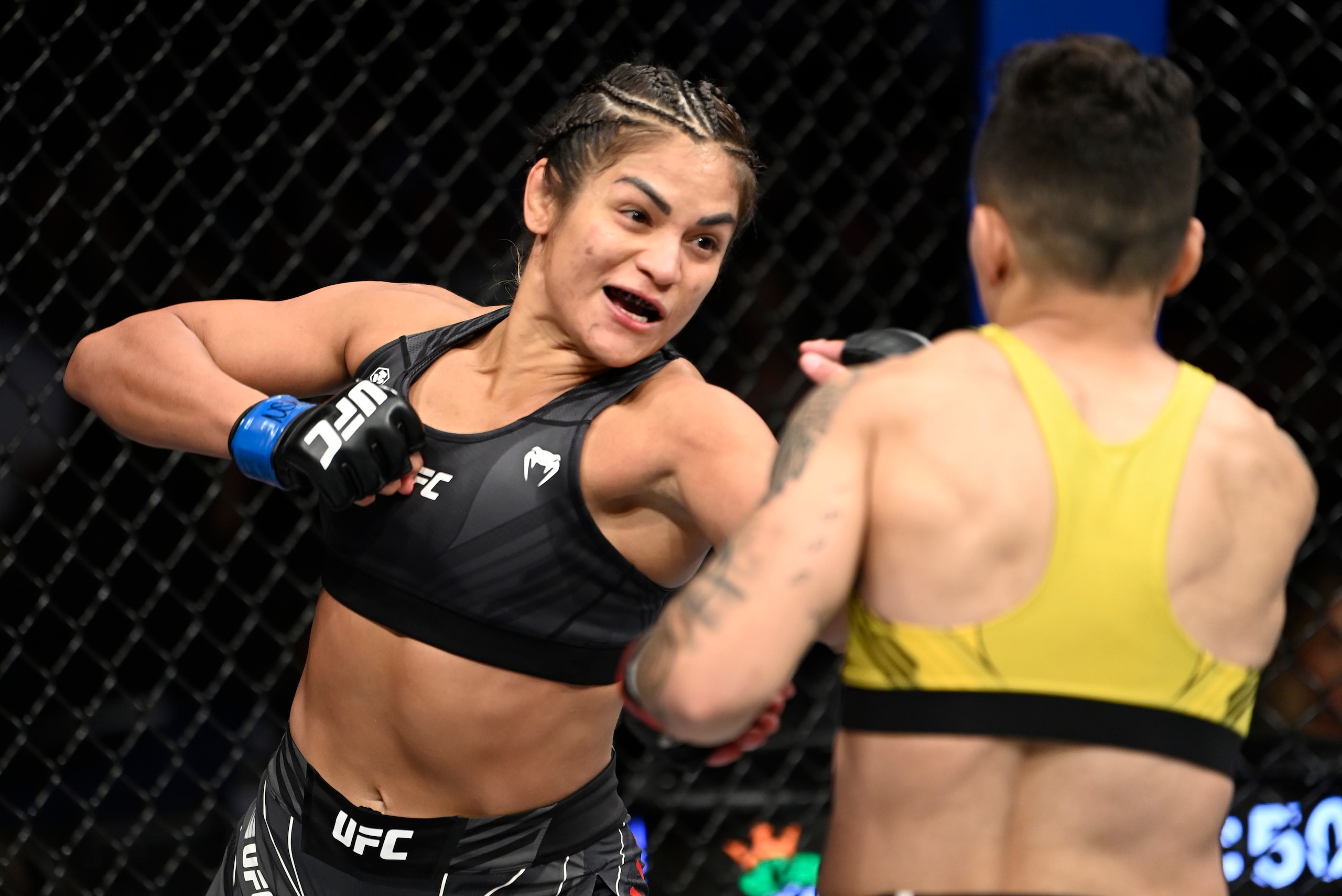 LAS VEGAS, NEVADA - SEPTEMBER 25: (L-R) Cynthia Calvillo punches Jessica Andrade of Brazil in their flyweight fight during the UFC 266 event on September 25, 2021 in Las Vegas, Nevada. (Photo by Jeff Bottari/Zuffa LLC)