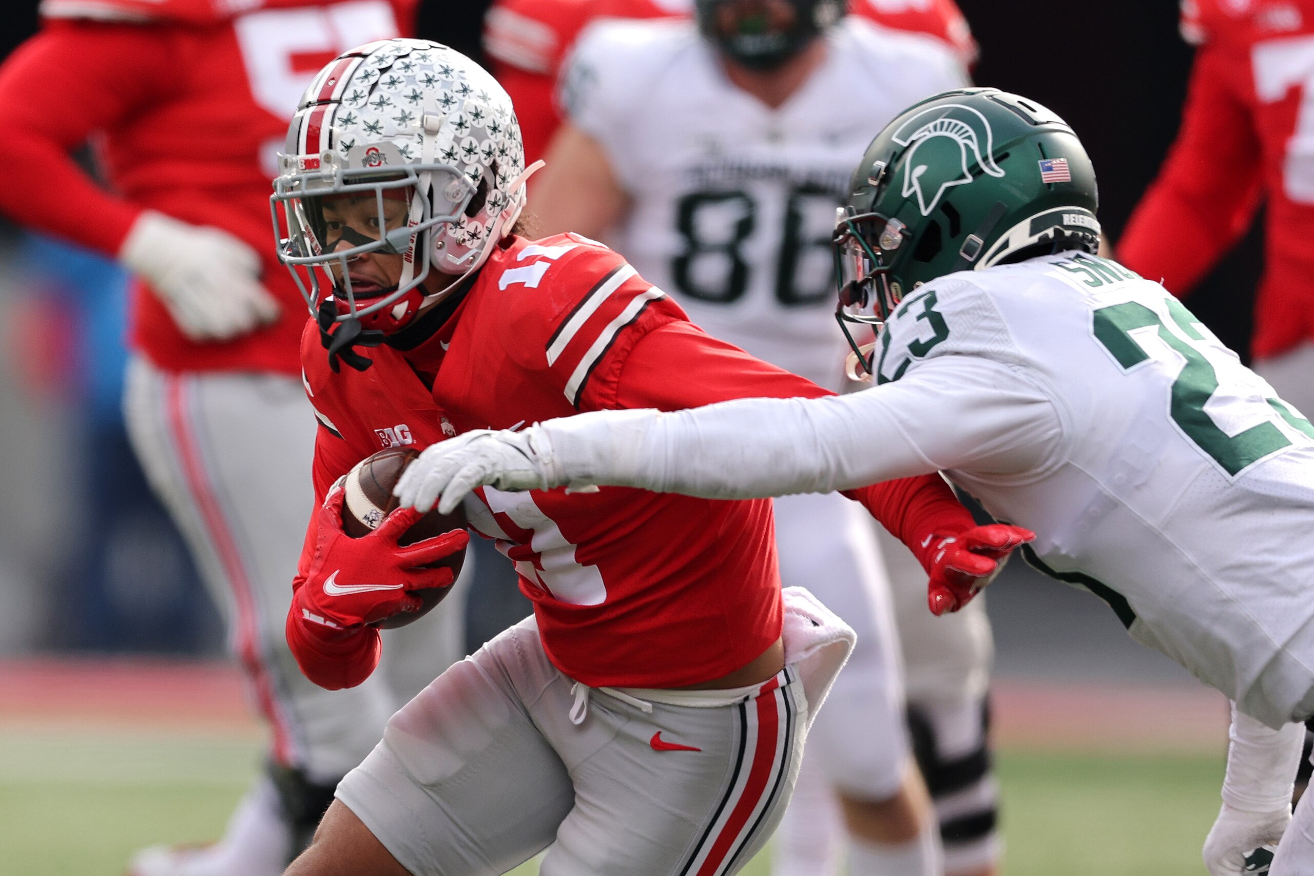 COLUMBUS, OHIO - NOVEMBER 20: Jaxon Smith-Njigba #11 of the Ohio State Buckeyes tries to get around the tackle of Darius Snow #23 of the Michigan State Spartans after a first half catch at Ohio Stadium on November 20, 2021 in Columbus, Ohio. (Photo by Gre