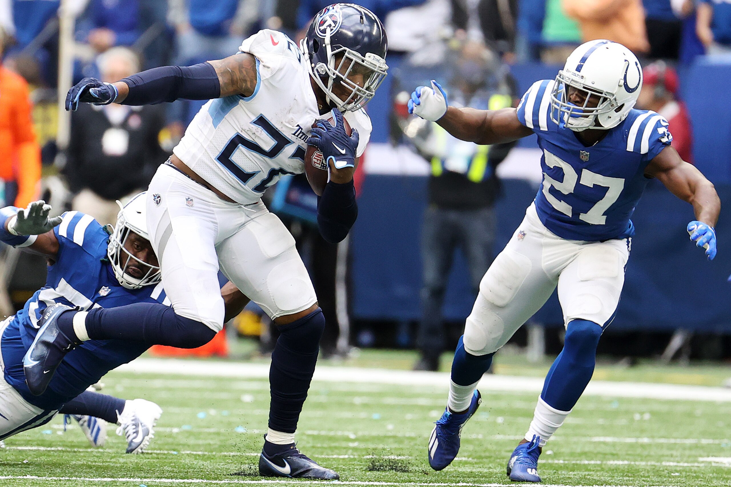 INDIANAPOLIS, INDIANA - OCTOBER 31: Derrick Henry #22 of the Tennessee Titans carries the ball against Xavier Rhodes #27 of the Indianapolis Colts in the second half at Lucas Oil Stadium on October 31, 2021 in Indianapolis, Indiana. (Photo by Andy Lyons/G