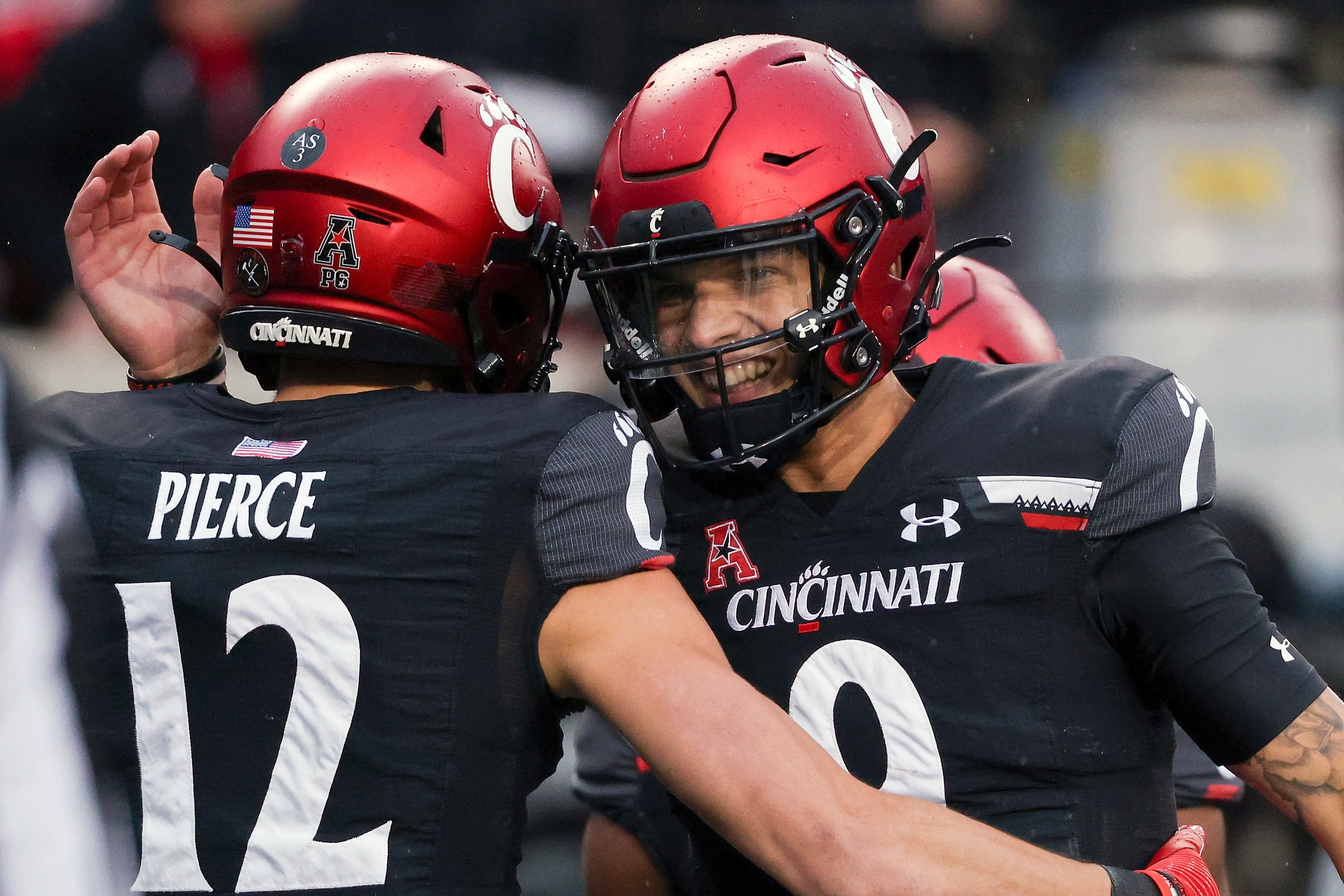 CINCINNATI, OHIO - NOVEMBER 20: Alec Pierce #12 and Desmond Ridder #9 of the Cincinnati Bearcats celebrate after scoring a touchdown in the second quarter against the SMU Mustangs at Nippert Stadium on November 20, 2021 in Cincinnati, Ohio. (Photo by Dyla