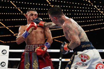 NEW YORK, NEW YORK - NOVEMBER 27:  George Kambosos punches Teofimo Lopez during their championship bout for Lopez’s Undisputed Lightweight title at The Hulu Theater at Madison Square Garden on November 27, 2021 in New York, New York. (Photo by Al Bello/Ge