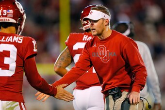 NORMAN, OK - OCTOBER 16:  Head coach Lincoln Riley of the Oklahoma Sooners congratulates quarterback Caleb Williams #13 after a touchdown against the Texas Christian University Horned Frogs in the fourth quarter at Gaylord Family Oklahoma Memorial Stadium