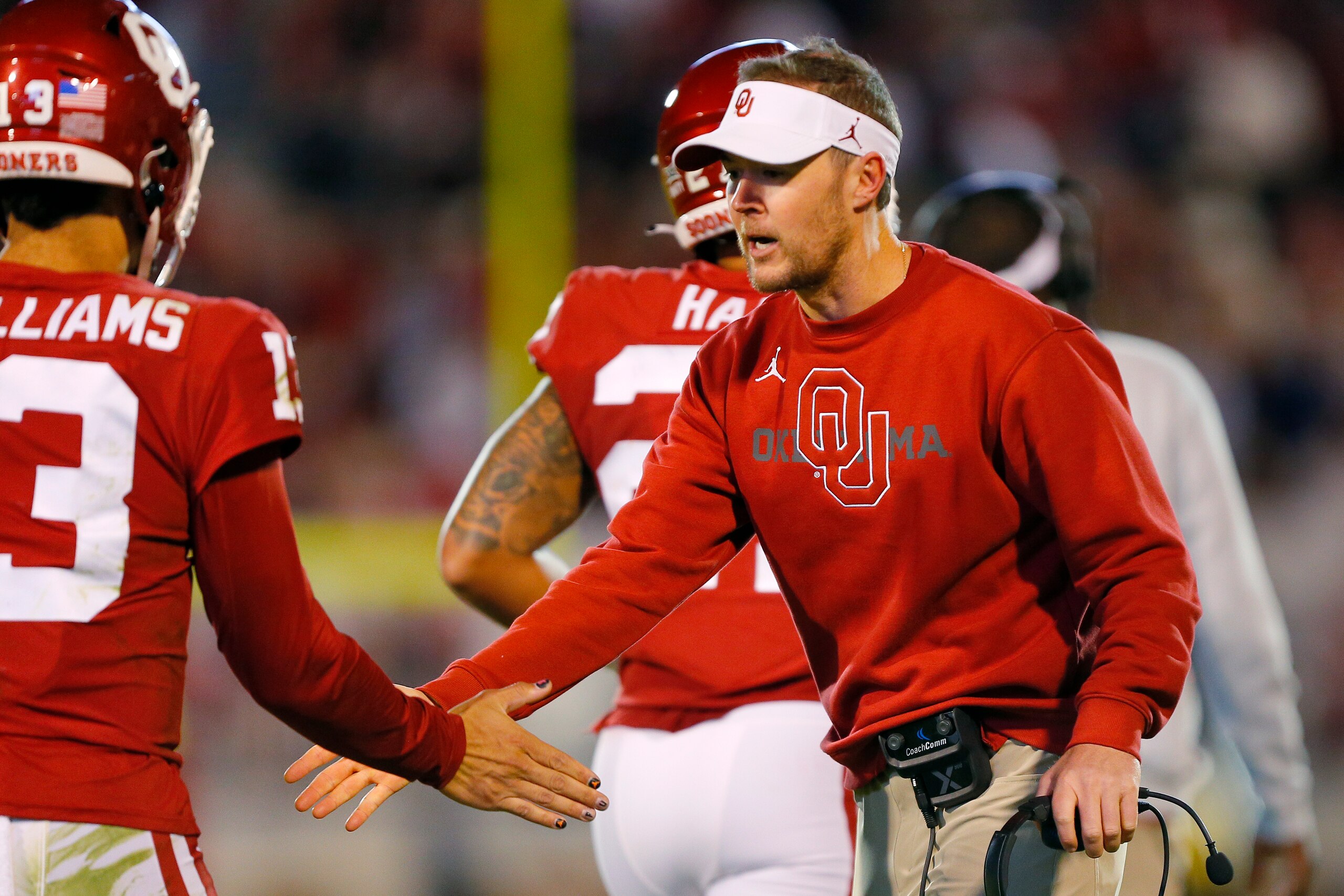 NORMAN, OK - OCTOBER 16:  Head coach Lincoln Riley of the Oklahoma Sooners congratulates quarterback Caleb Williams #13 after a touchdown against the Texas Christian University Horned Frogs in the fourth quarter at Gaylord Family Oklahoma Memorial Stadium
